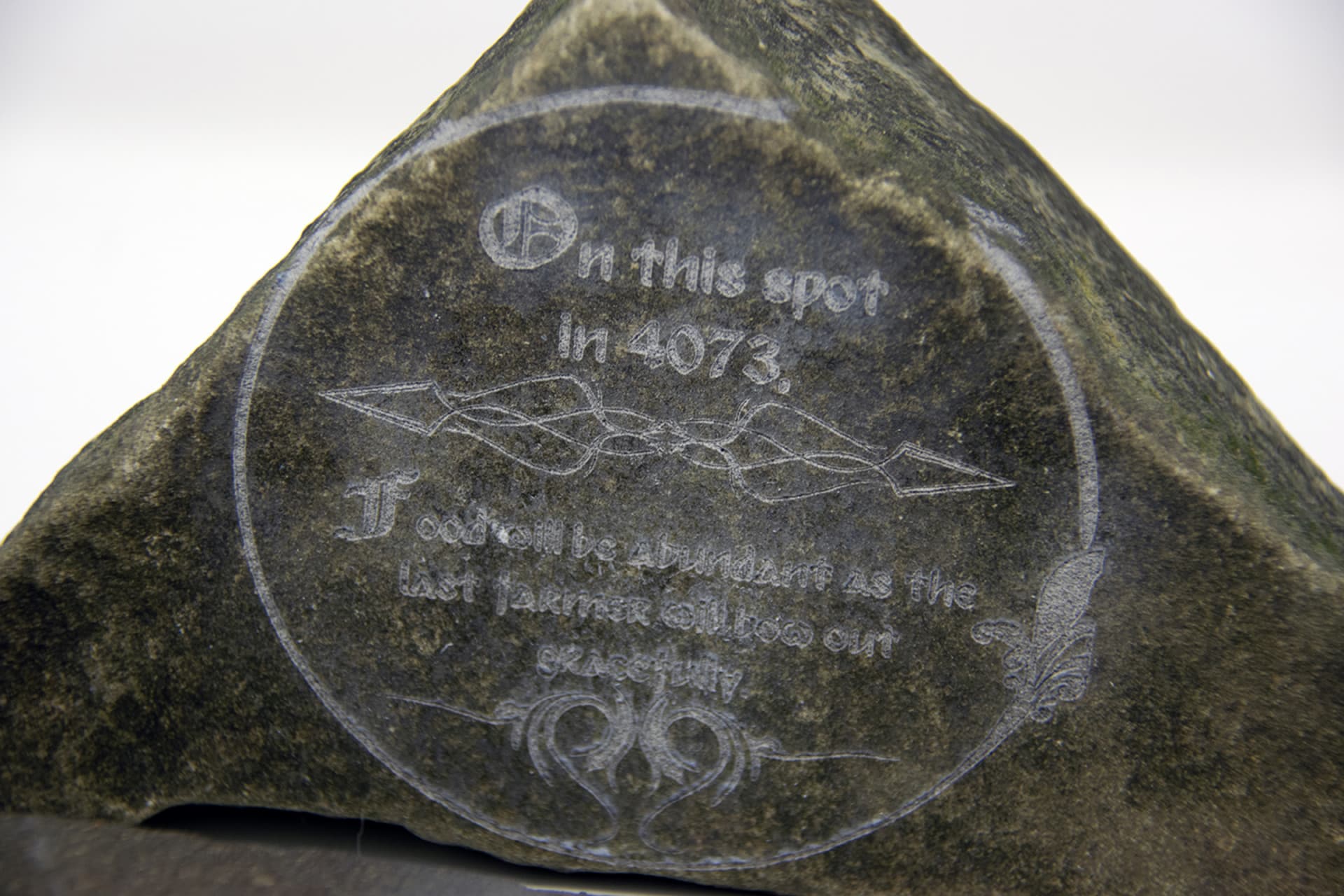 A triangle stone saying that the last farmer will stop living here in the year 4073.