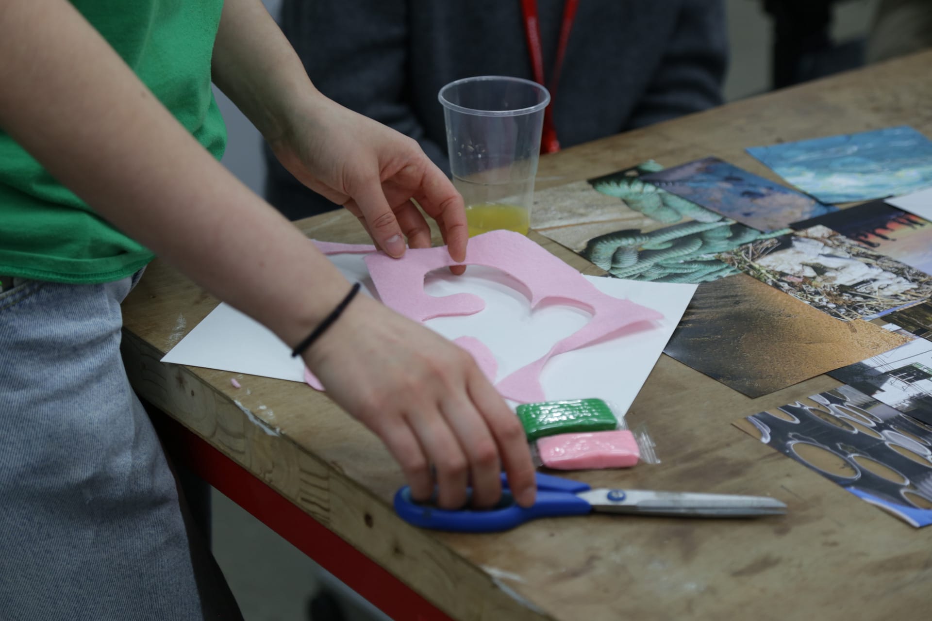 Someone cutting pink felt 