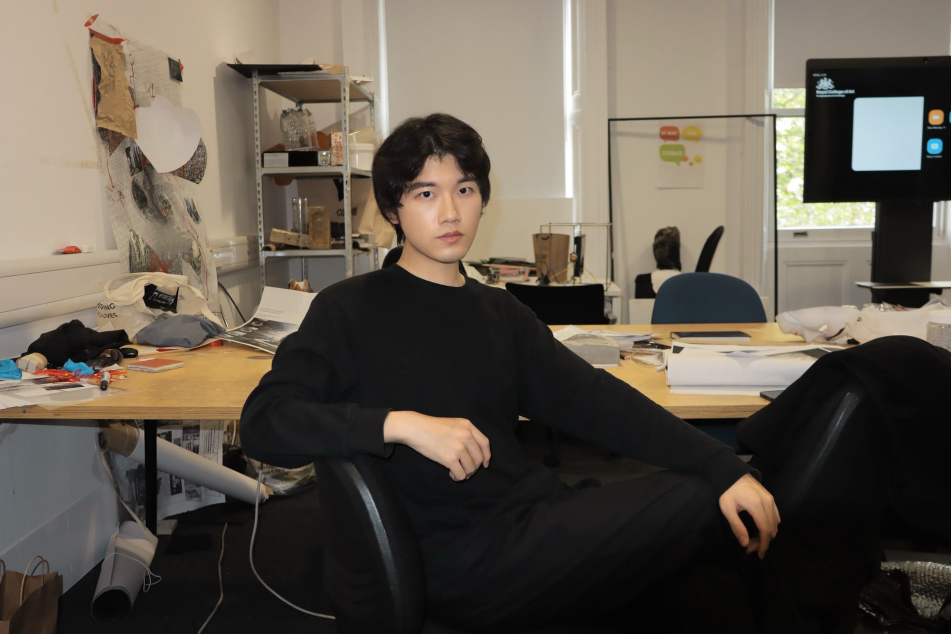 Chenyao sits on a chair in her studio