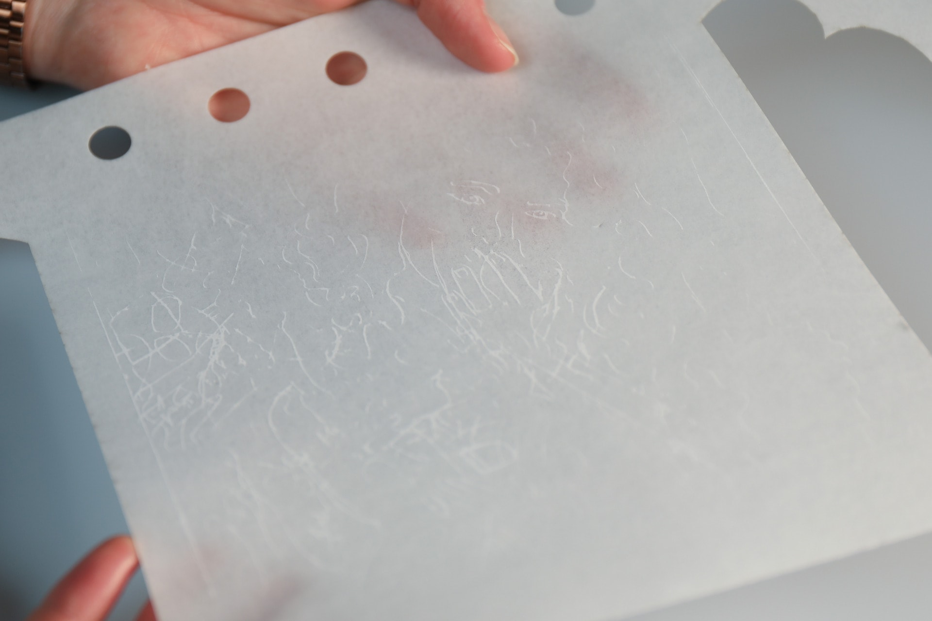 Illustration applied with laser cutter visible through light