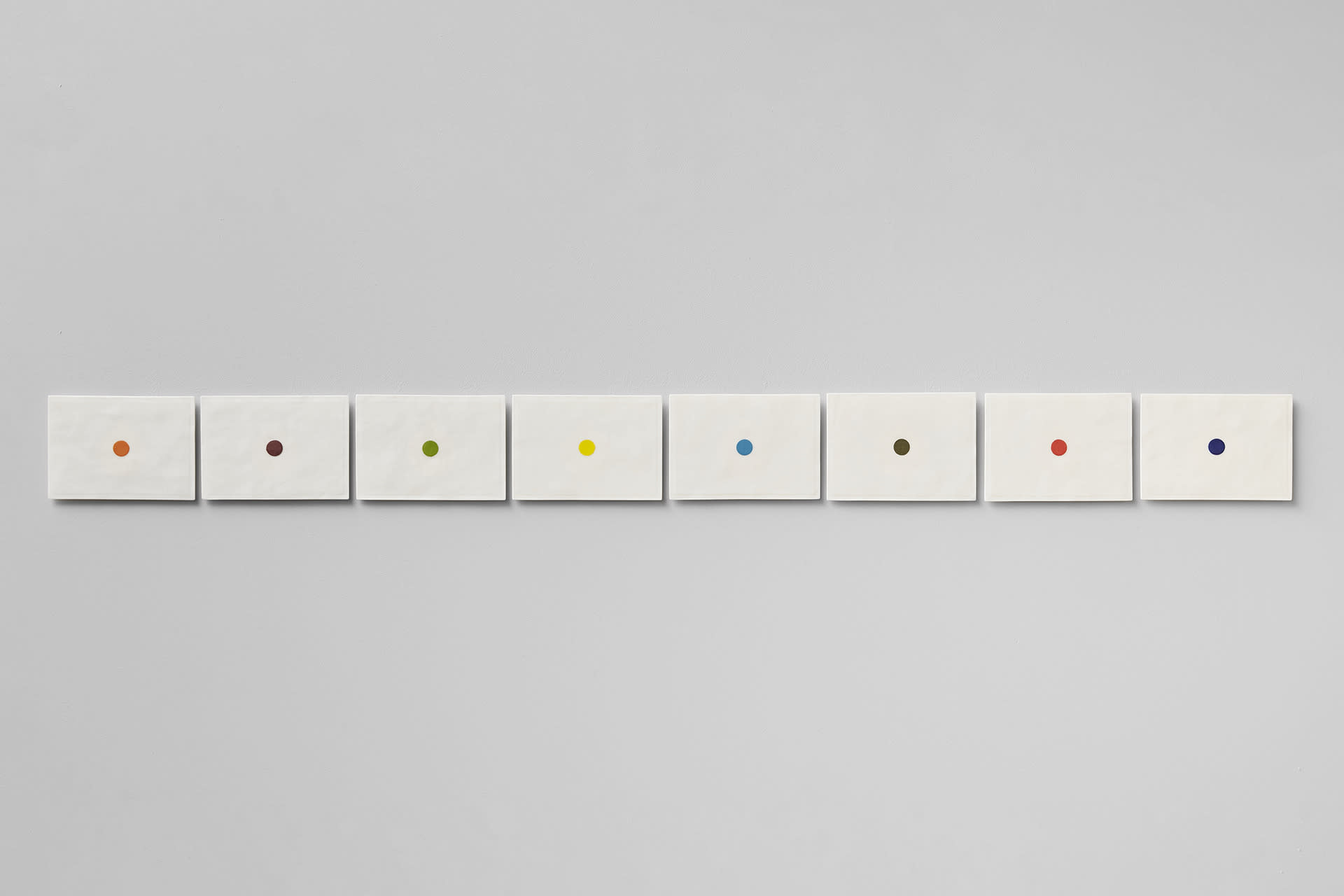 Eight porcelain ceramic postcards with a central dot in coloured slip