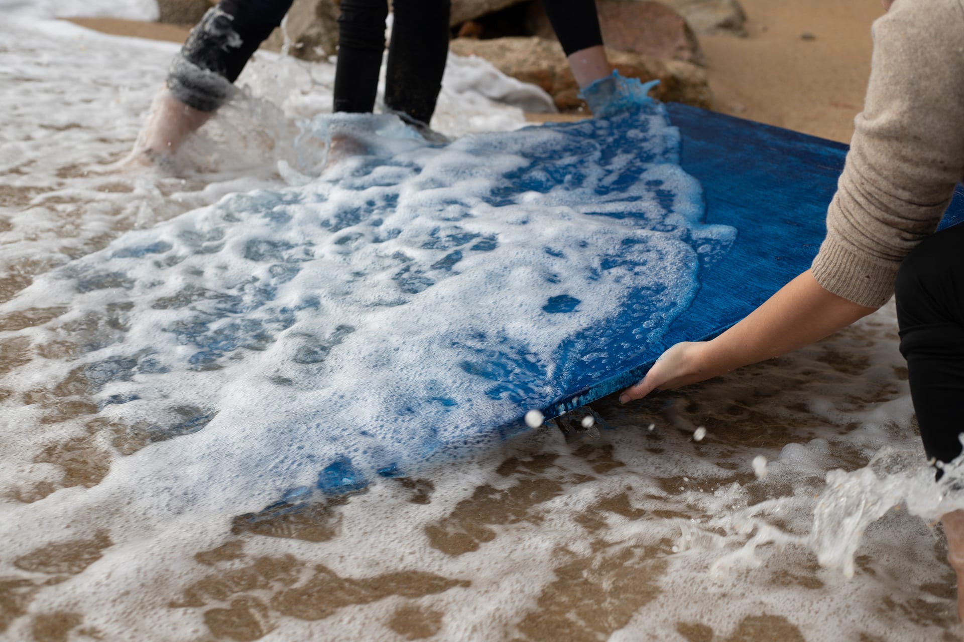 Showing the process of submerging the canvas in the sea