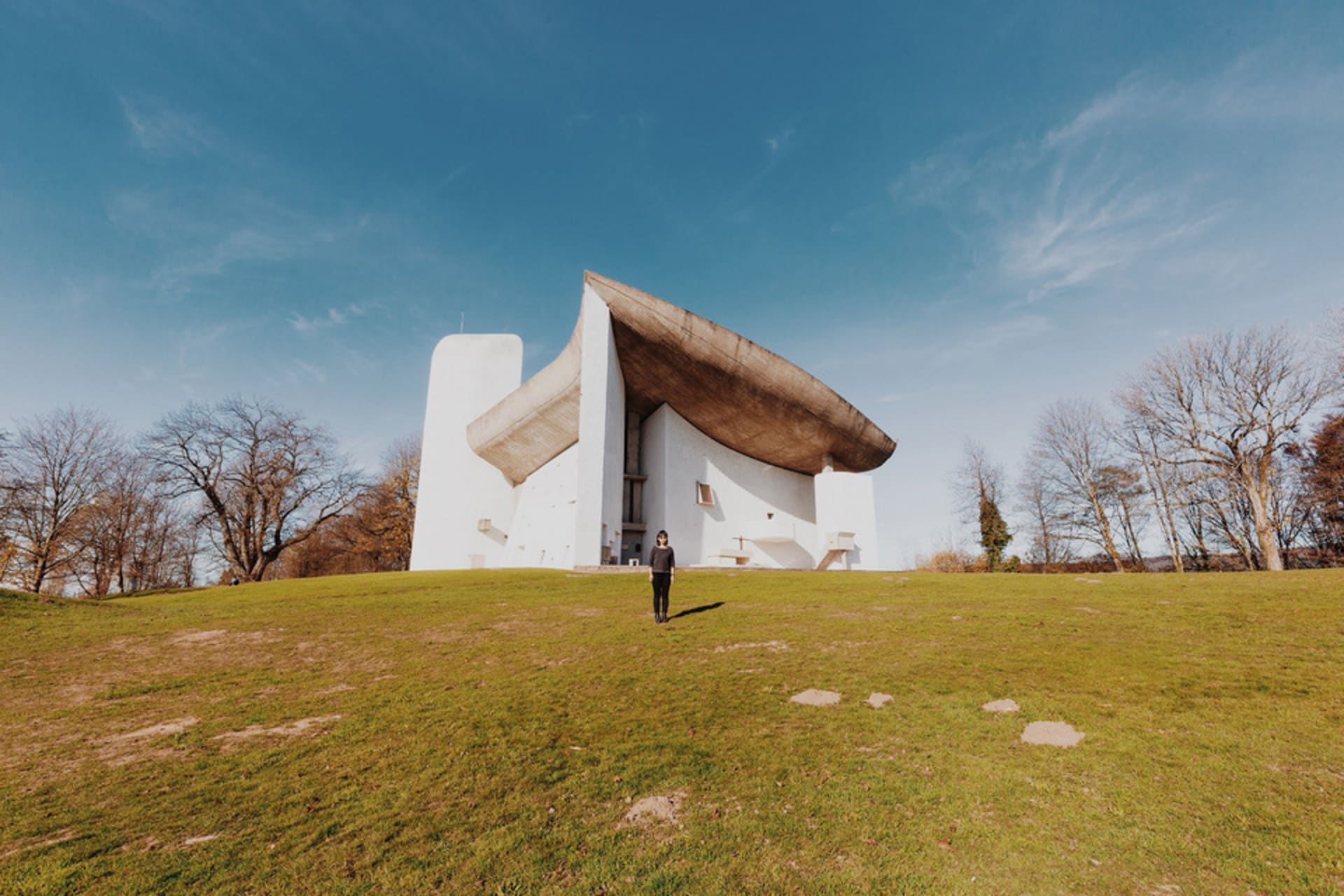 Stephanie Cheung standing in front of Le Corbusier's Colline Notre Dame du Haut, in Ronchamp, France. 