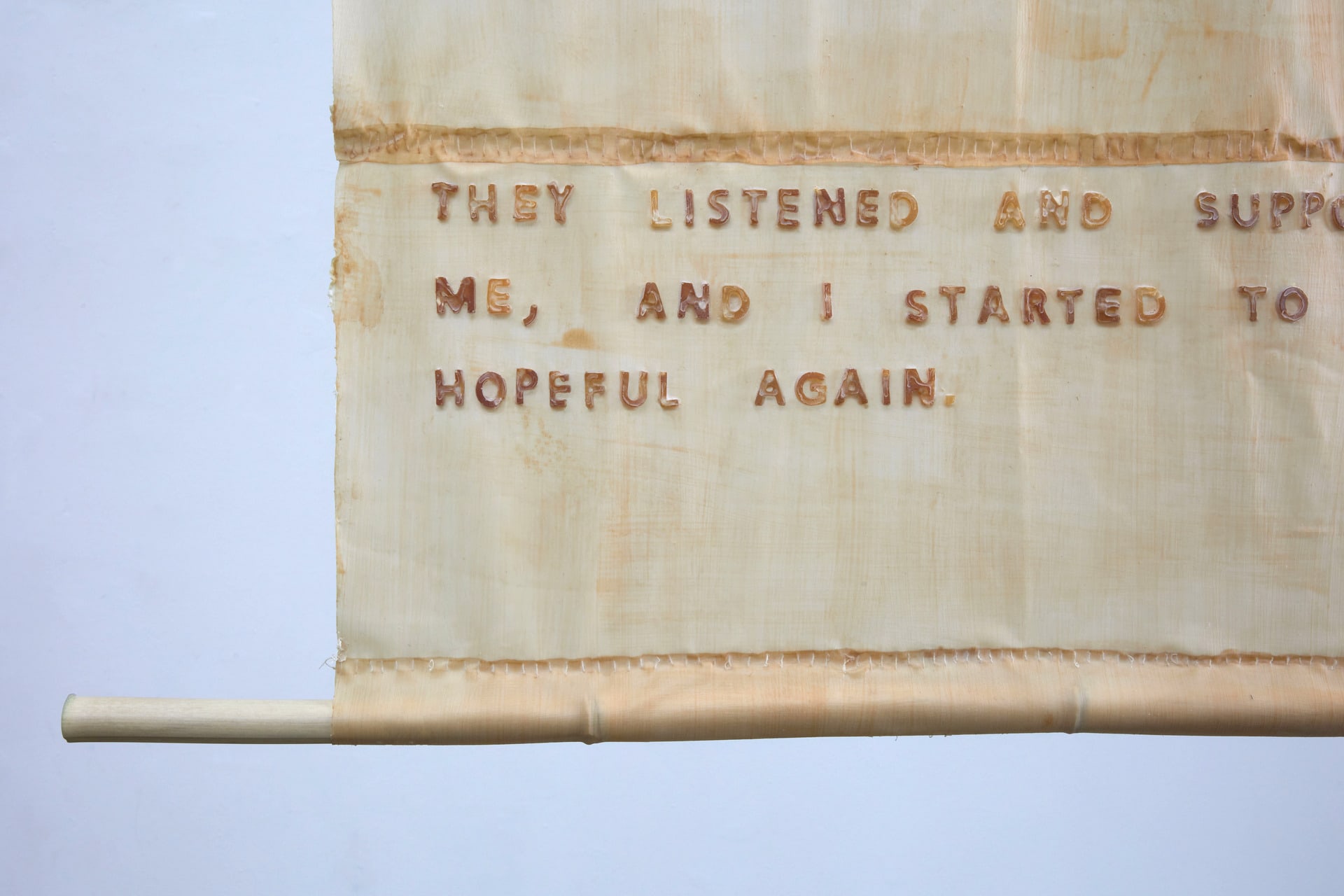 Three latext scrolls narrating a womens first encounter of sex, hung on bamboo using hemp rope.