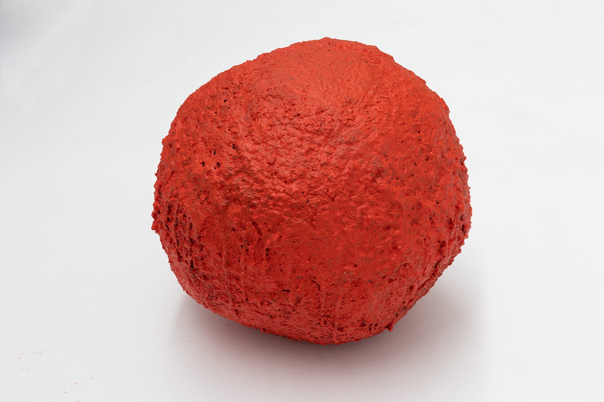 Red boulder with a carborundum surface textur