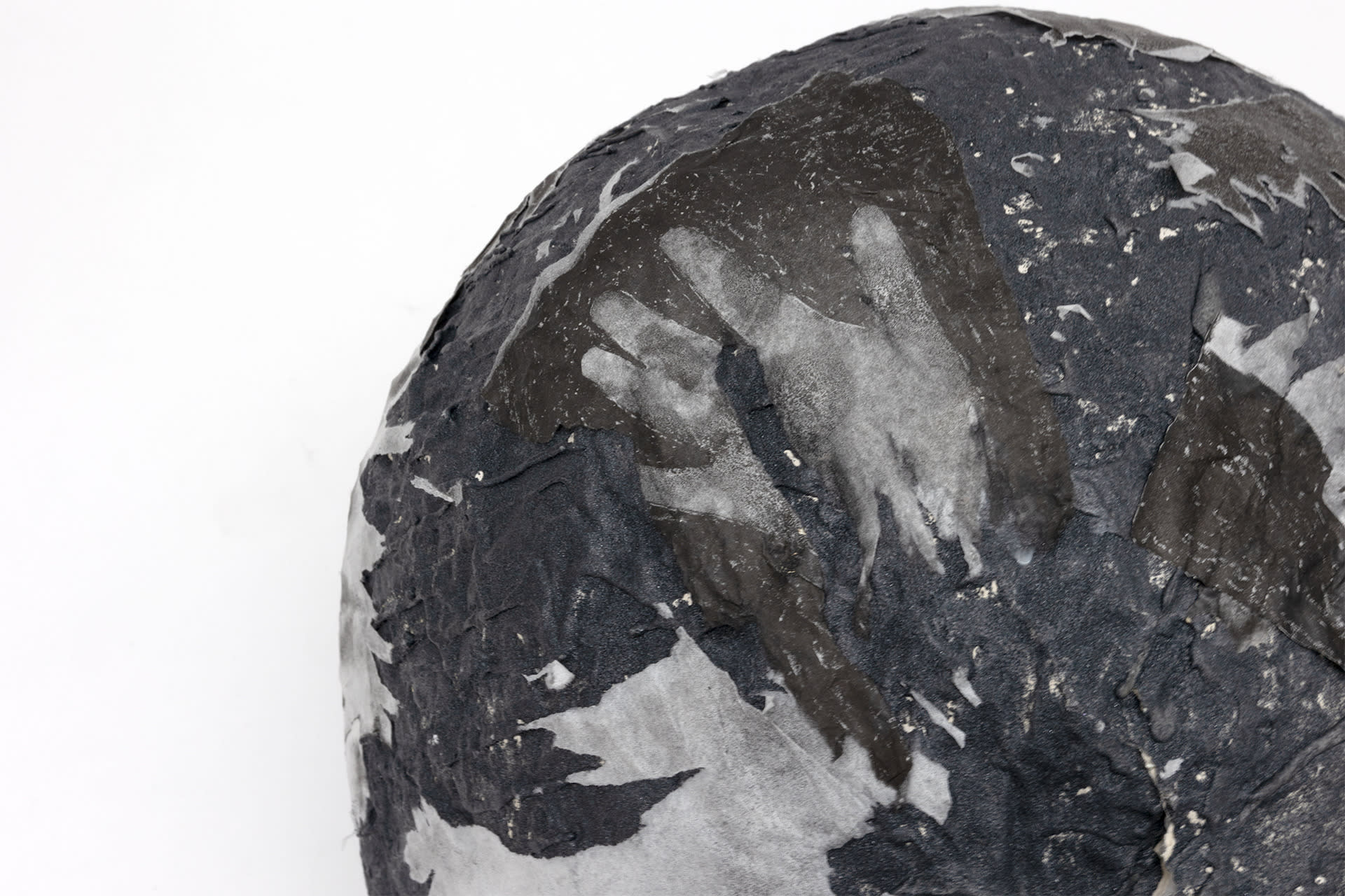 Ascension IV, a boulder with raw carborundum and lithographs on its surface