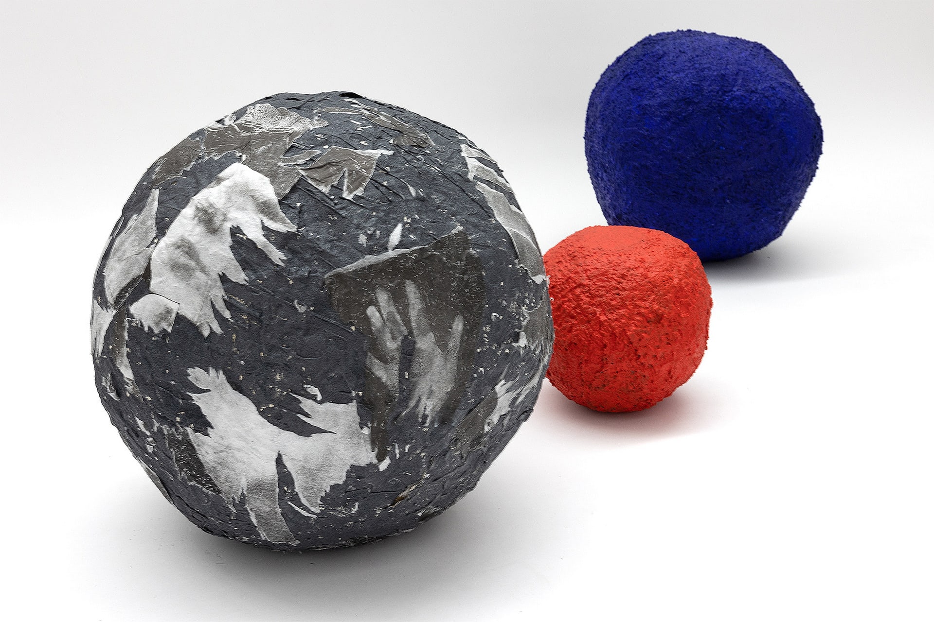 Group of three boulders, one with carborundum, one red and one blue