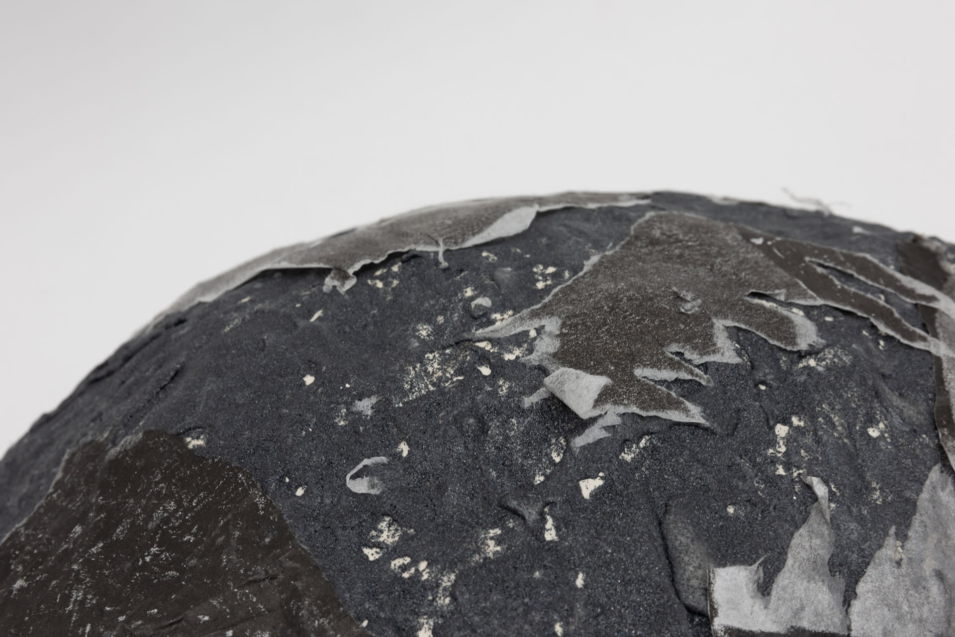 Close up of the surface of Ascension IV, a boulder that has lithographs on its surface that have been teared off. 