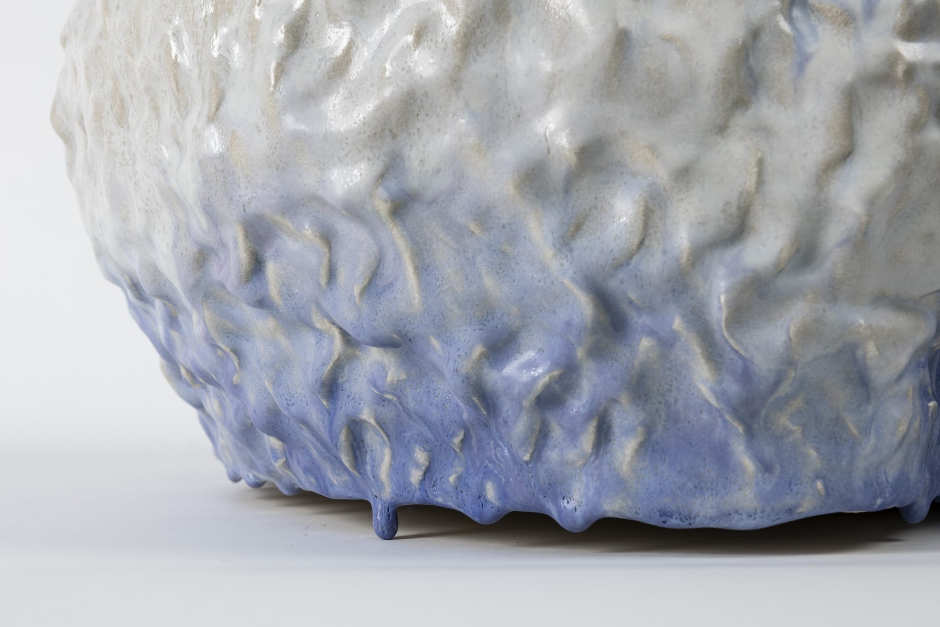 Tactile large scale ceramic piece in blue and white.  Colours flowing together. Anthropomorphic figure, closeup