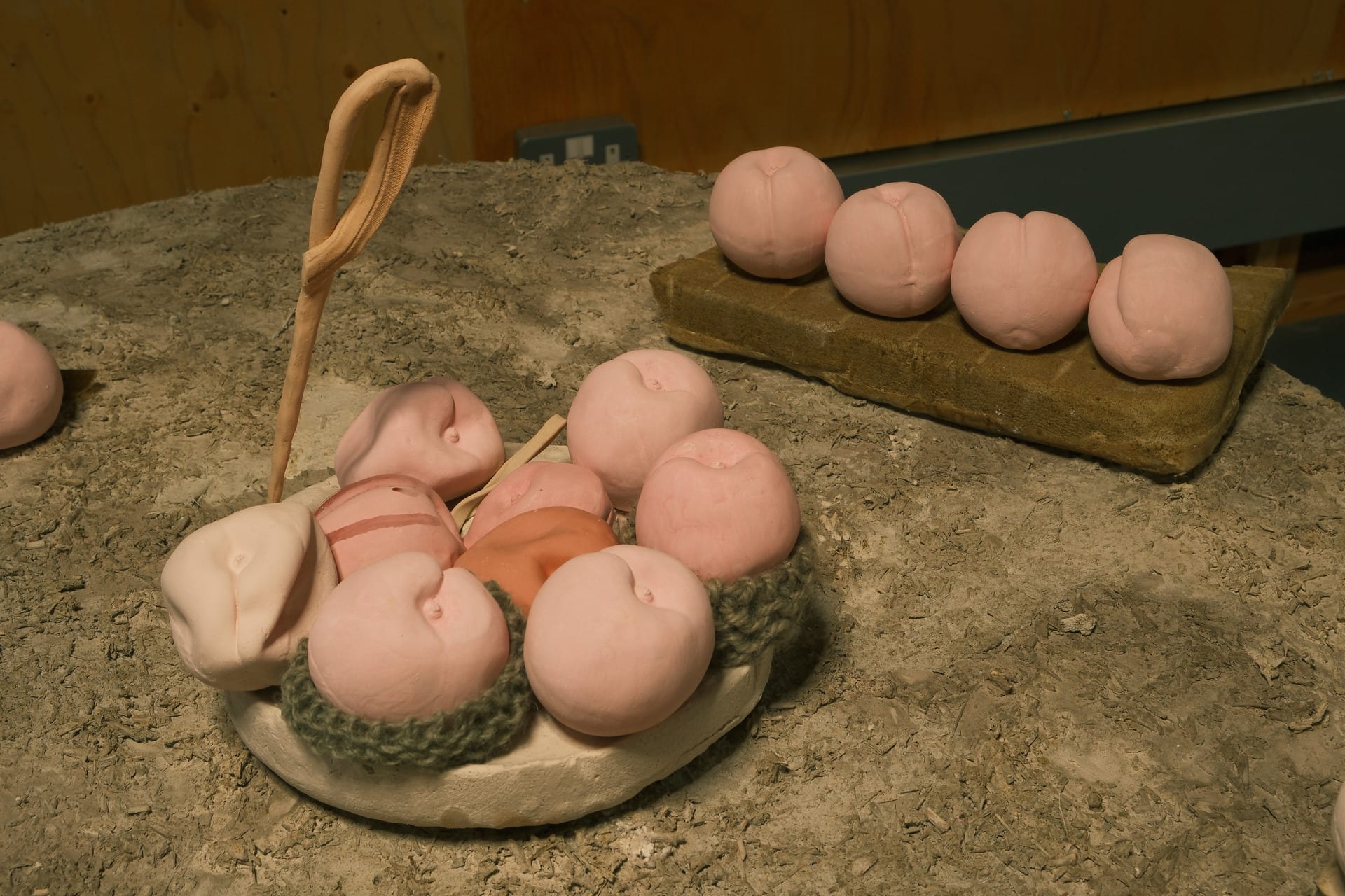 Pink peach ceramic pieces are placed on the table to form a dinner(detail)