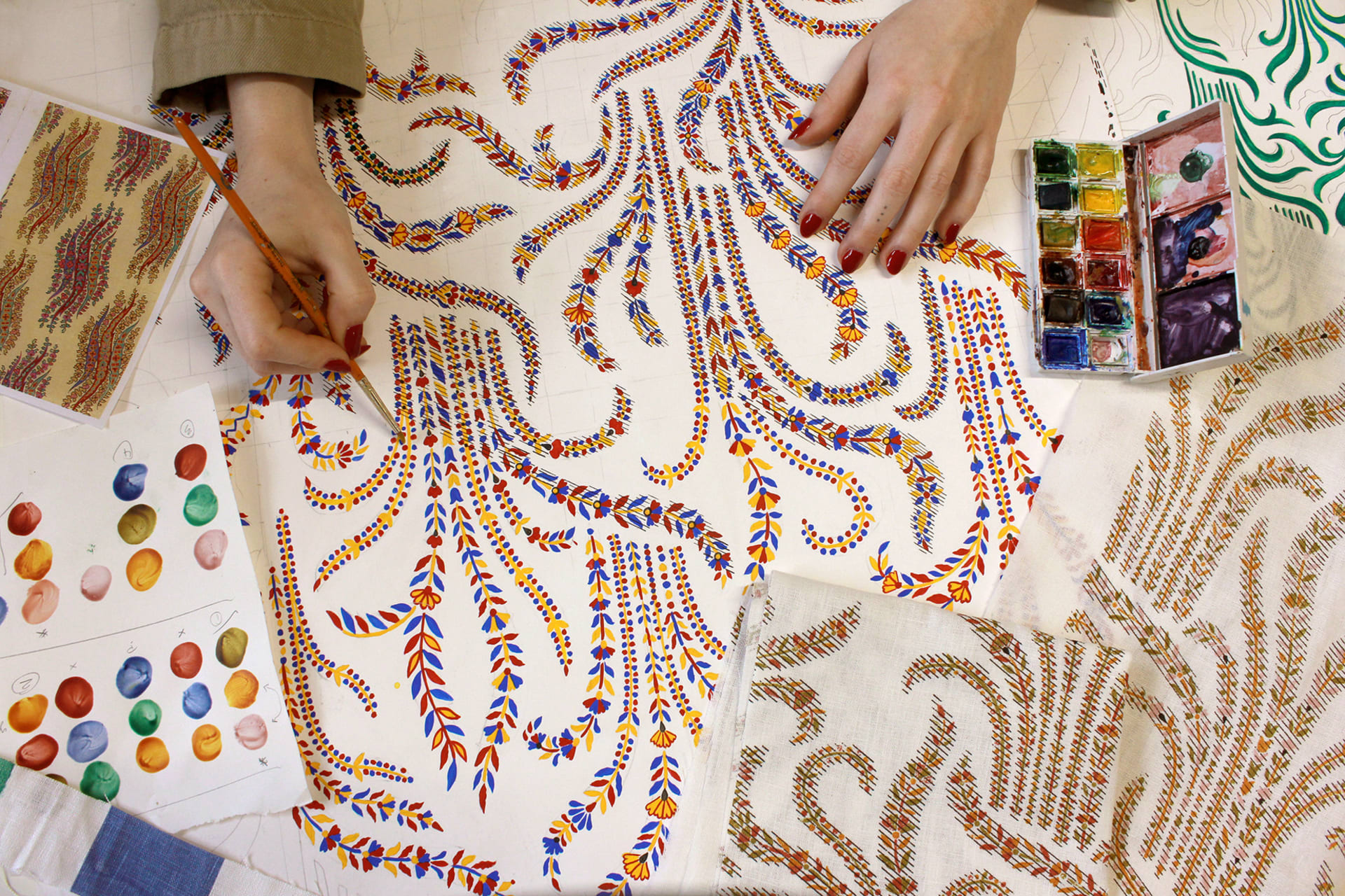 Ellen Merchant hand painting the original artwork for her fabric design titled 'Wild Grass'.