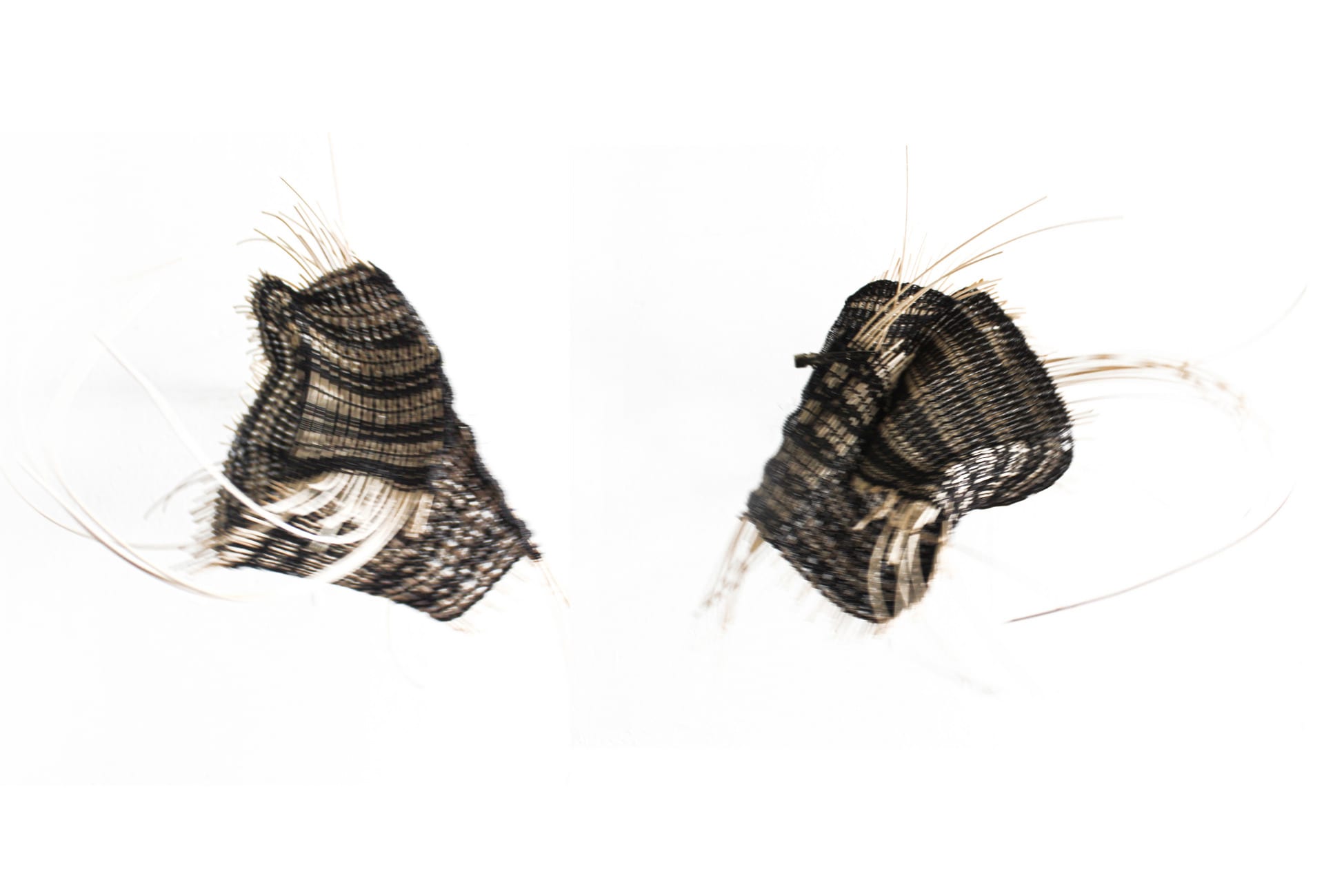 A handcrafted item woven from rattan, combined with delicate black lace threads