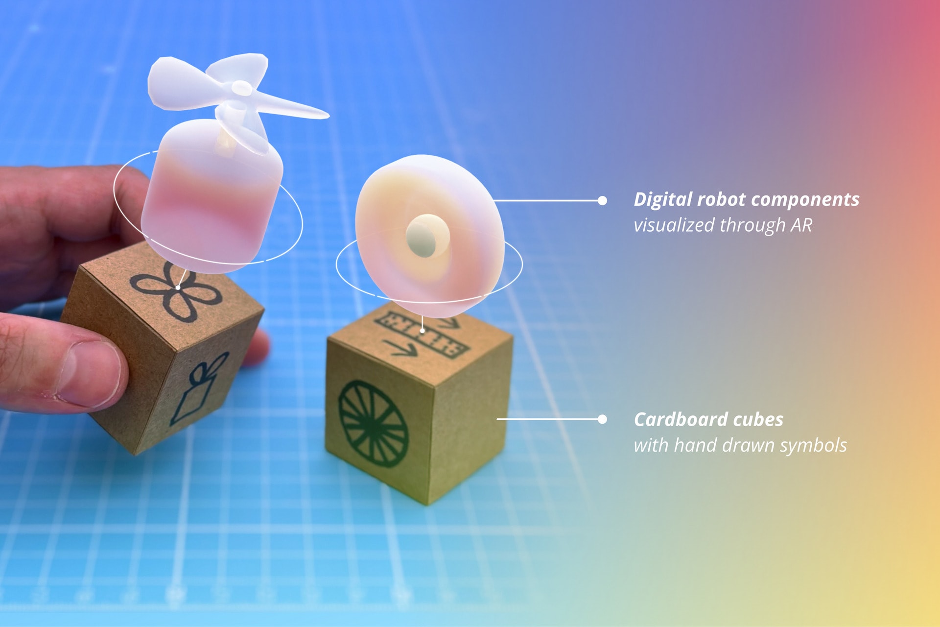 Digital robot components visualized through AR on top of cardboard cubes