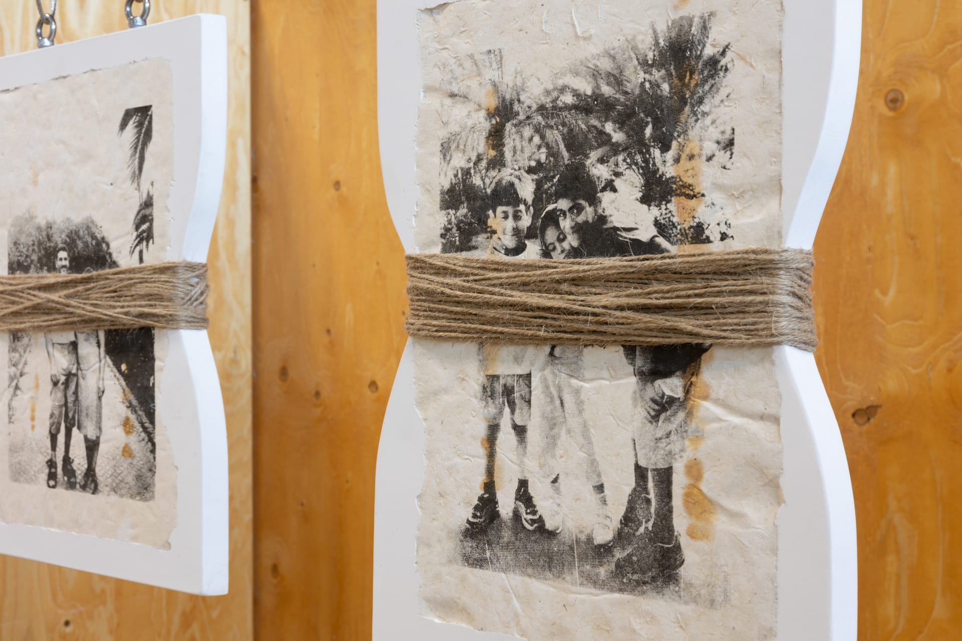 Screen prints of my family embedded into jesmonite. The two jesmonite tiles wrapped with hemp rope, hng from steel wire. 