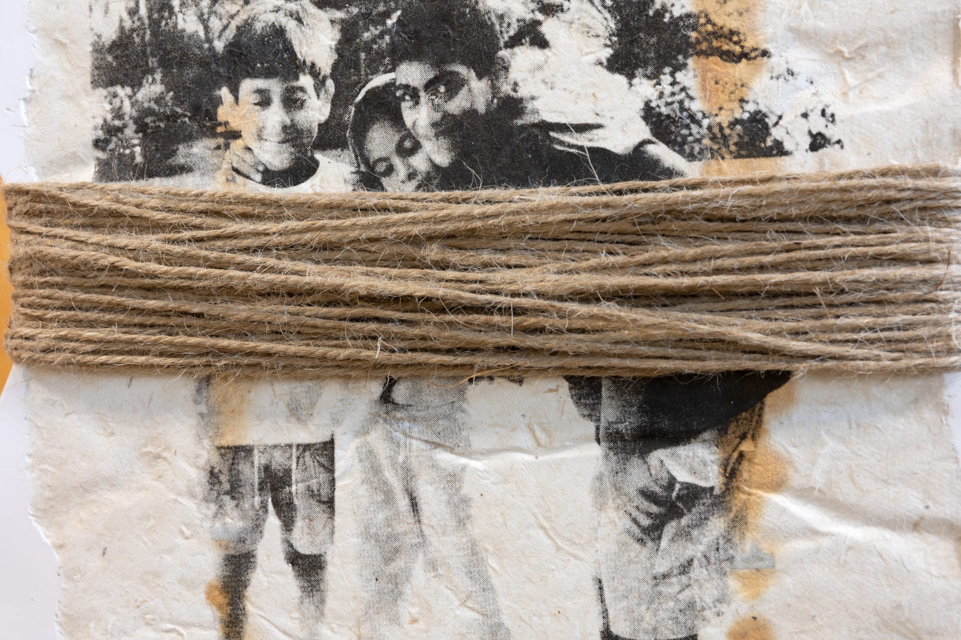 Screen prints of my family embedded into jesmonite. The two jesmonite tiles wrapped with hemp rope, hng from steel wire. 