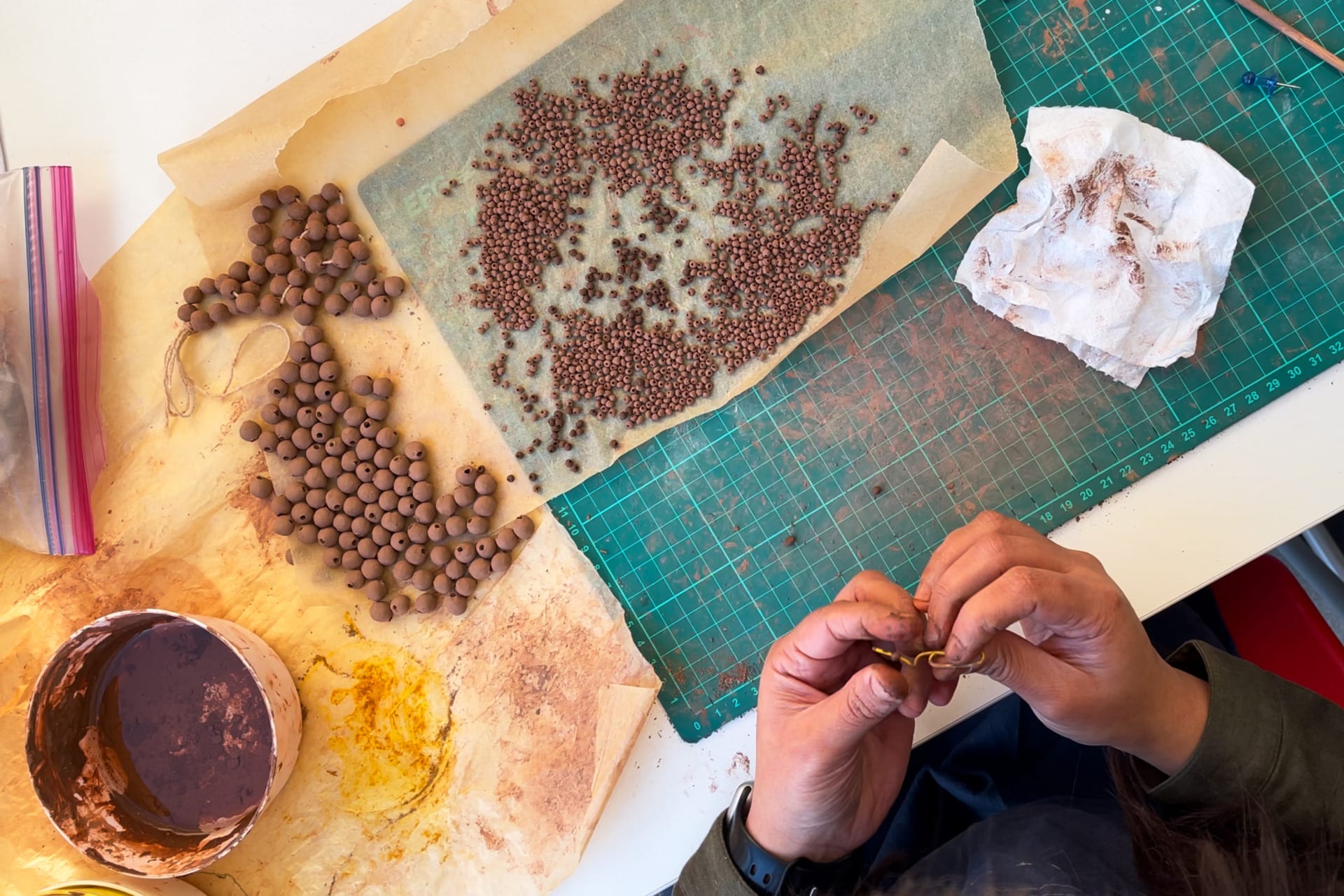 hands with clay beads