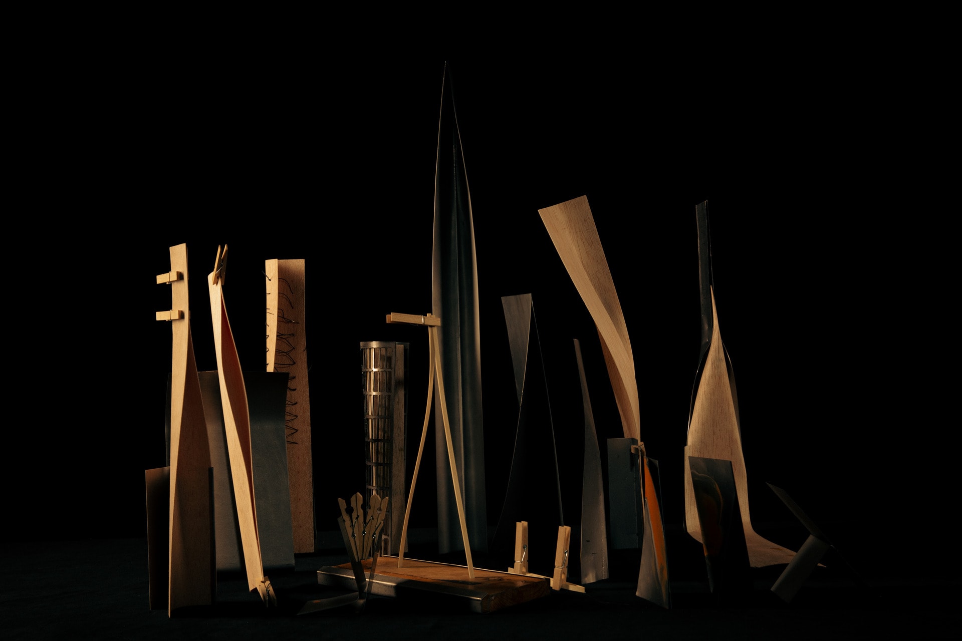 A landscape of wooden and steel maquettes, folded and manipulated to capture a sense of height. 