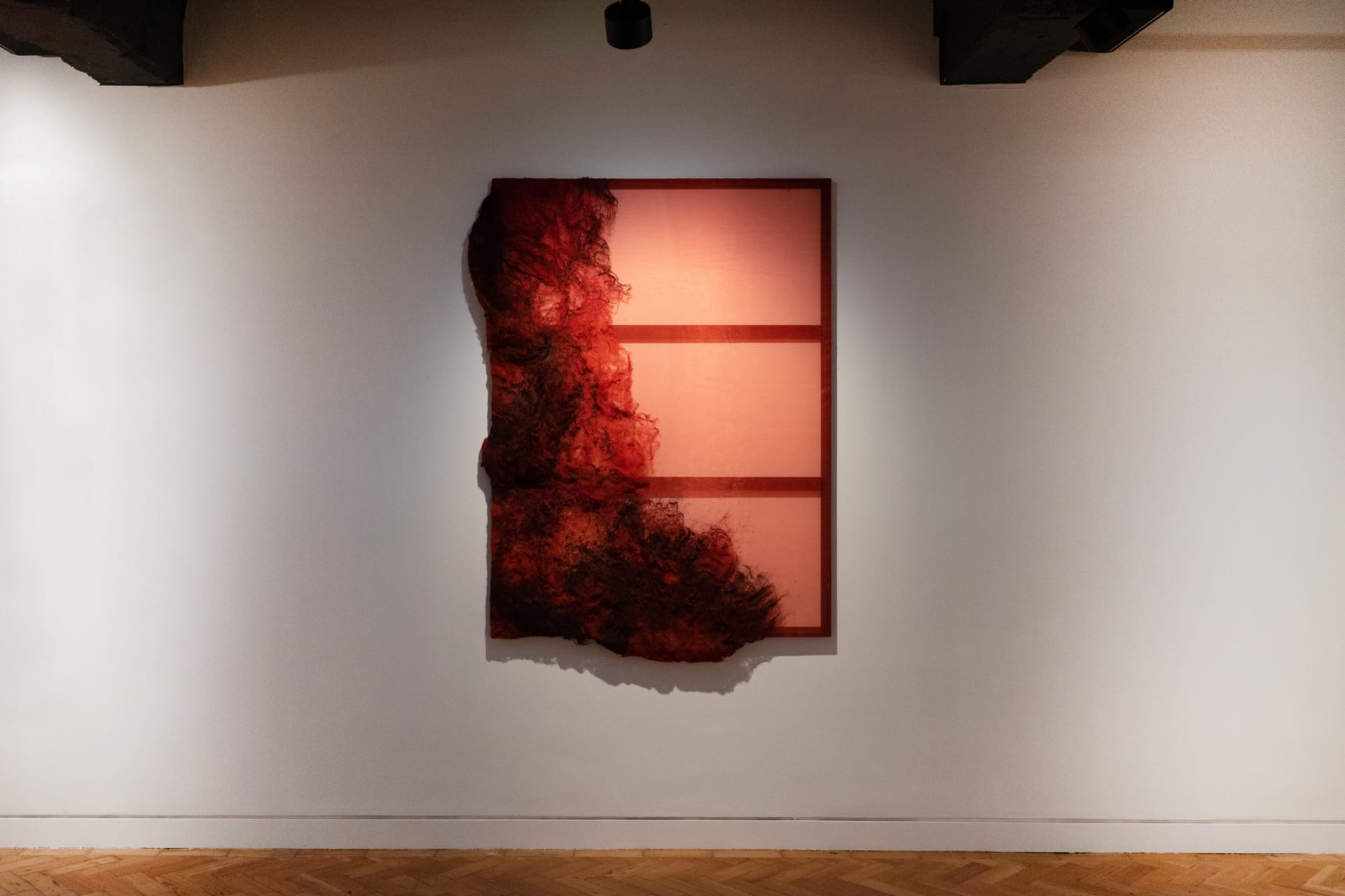 an expanded painting display in the middle of a gallery space. 