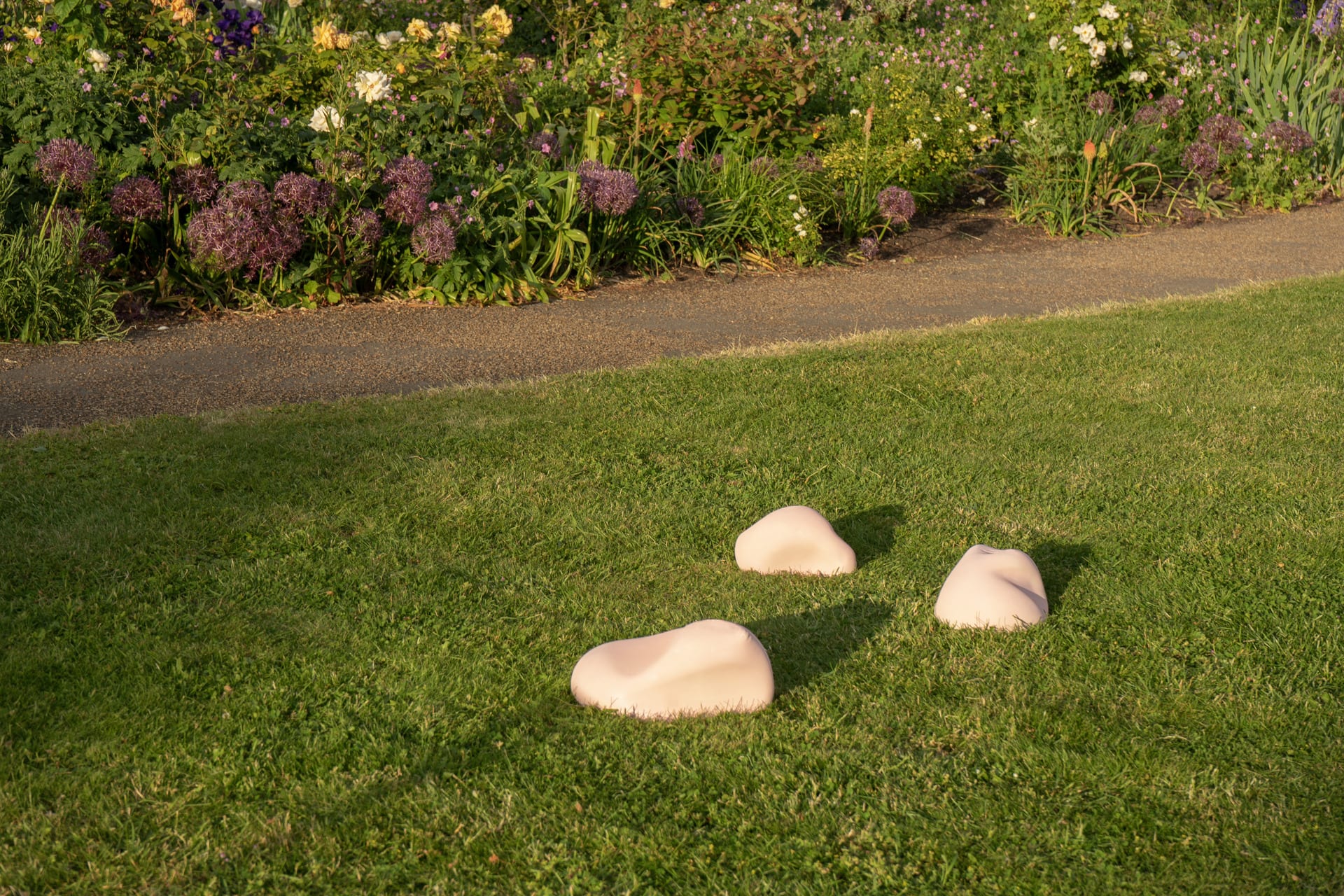 pink cushions on grass formed from homoerotic paintings