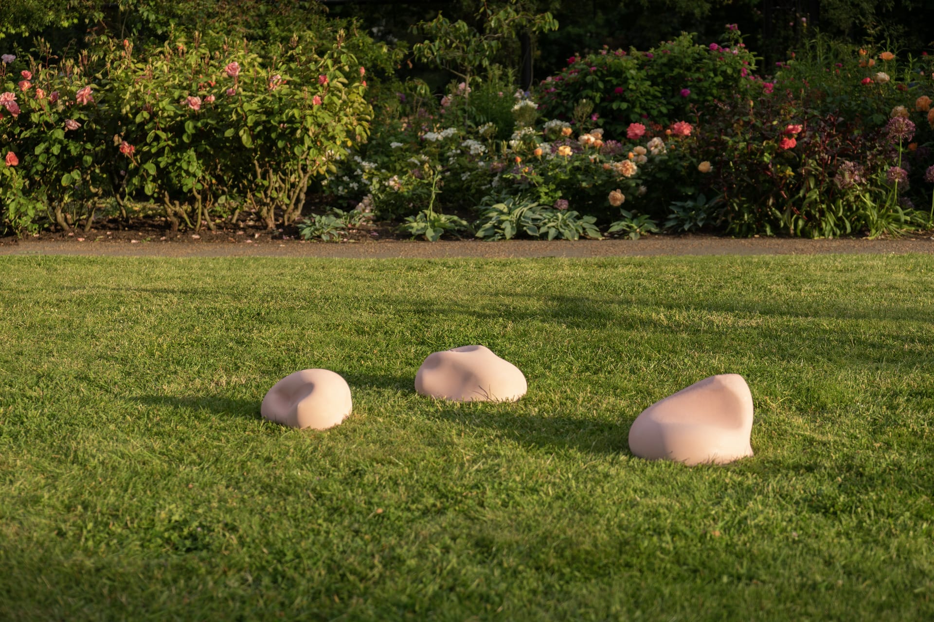 pink cushions on grass formed from homoerotic paintings