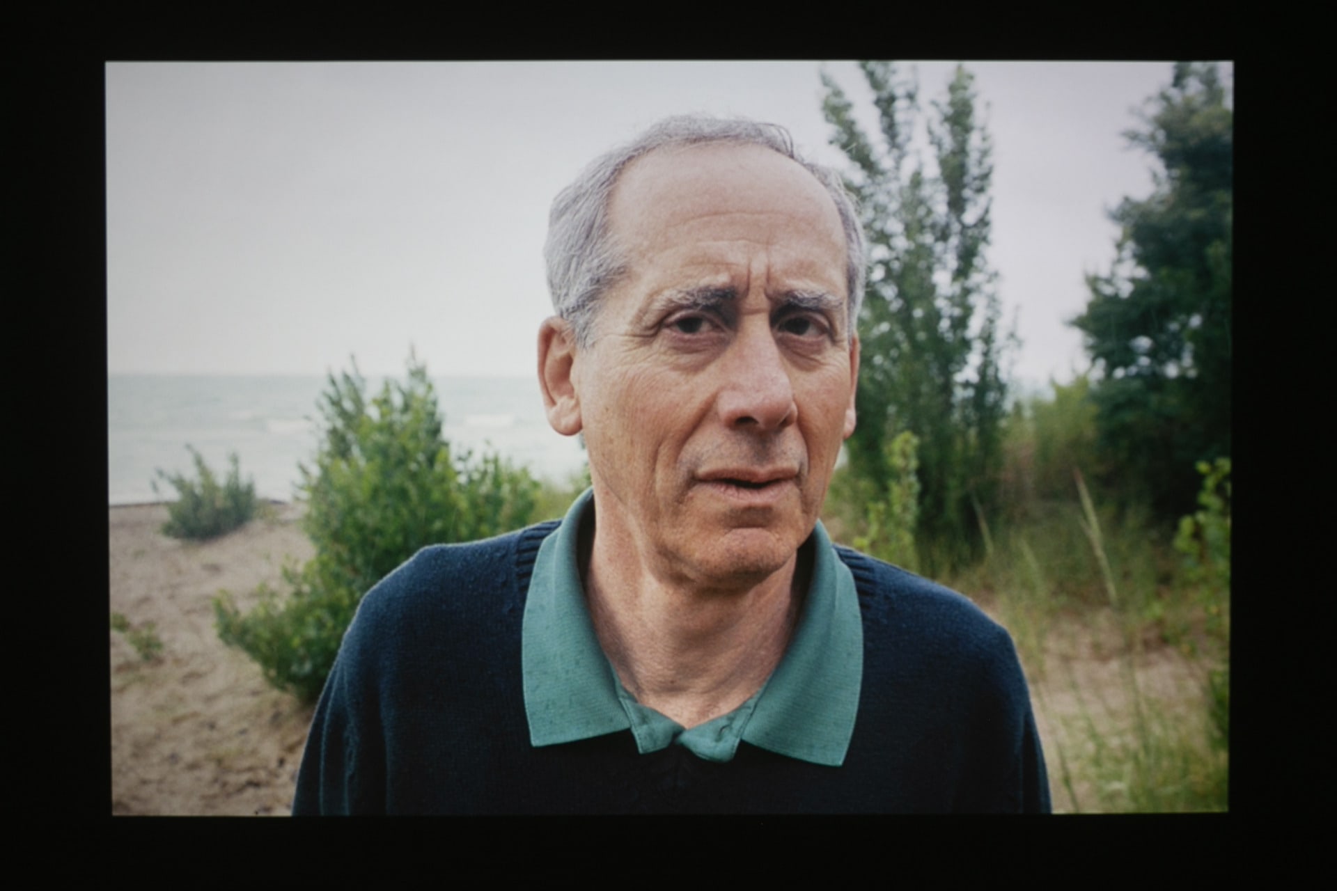 Man on Beach looking at camera confused