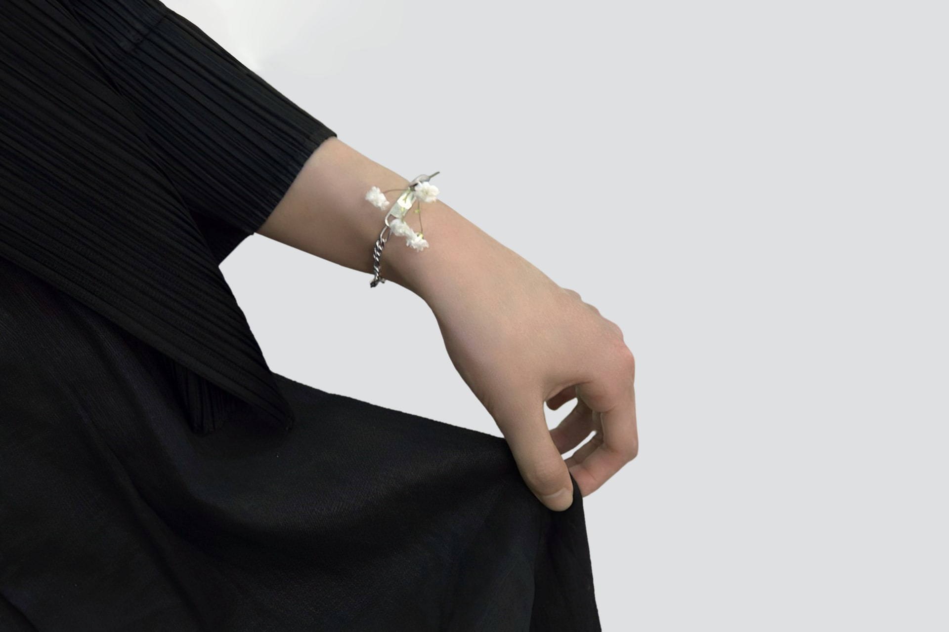 Bracelet. Picture 3. Close-up view with the model lifting the hem of the skirt.
