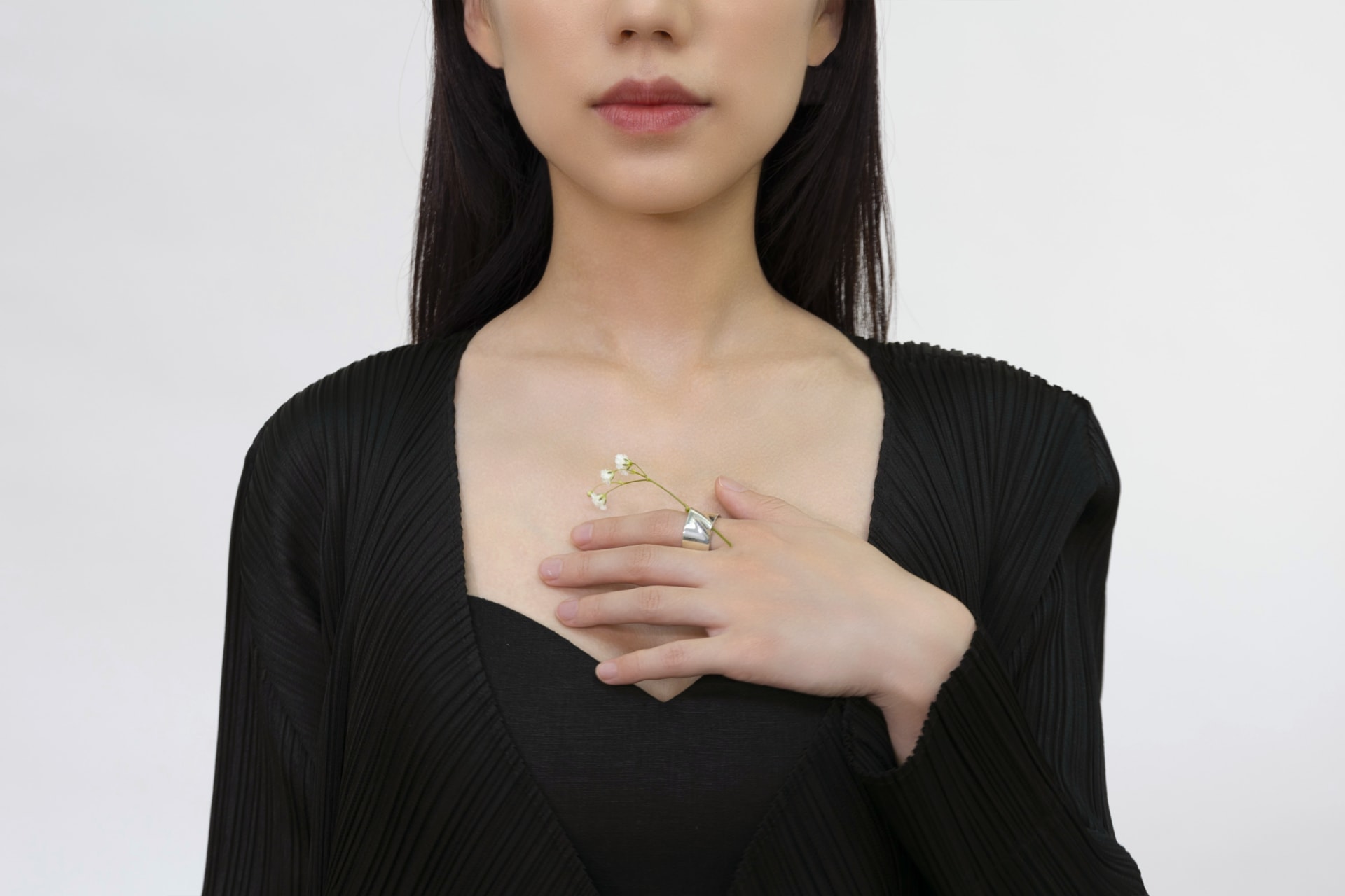 Ring. Picture 3. Front view with the model putting her hand on the chest.