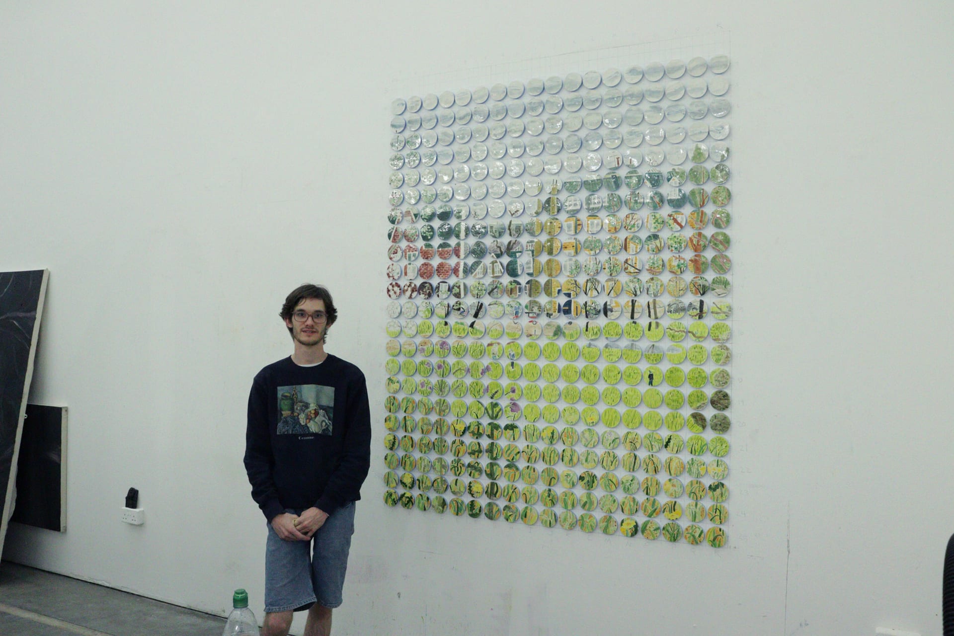 Artist standing next to ceramic piece