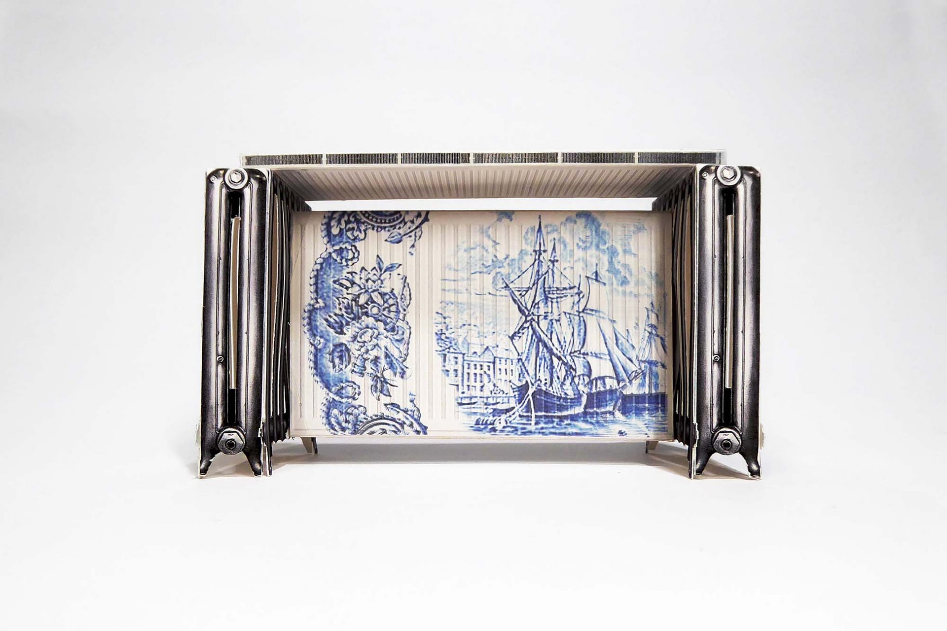 Four radiators arranged into the form of a dining table, overlaid with blue Delft pattern.