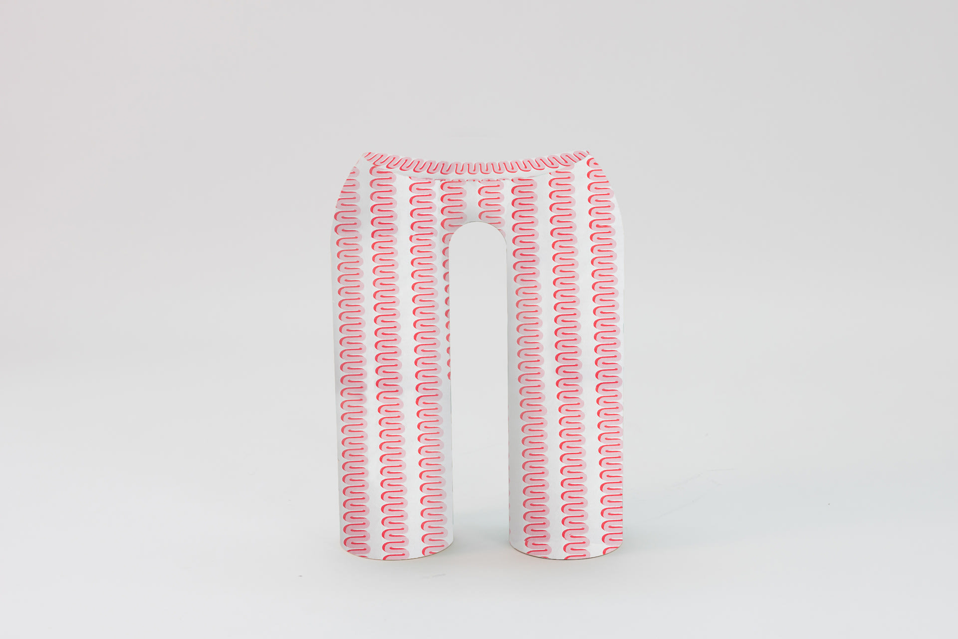 pink patterned trousers as a cover for the stool