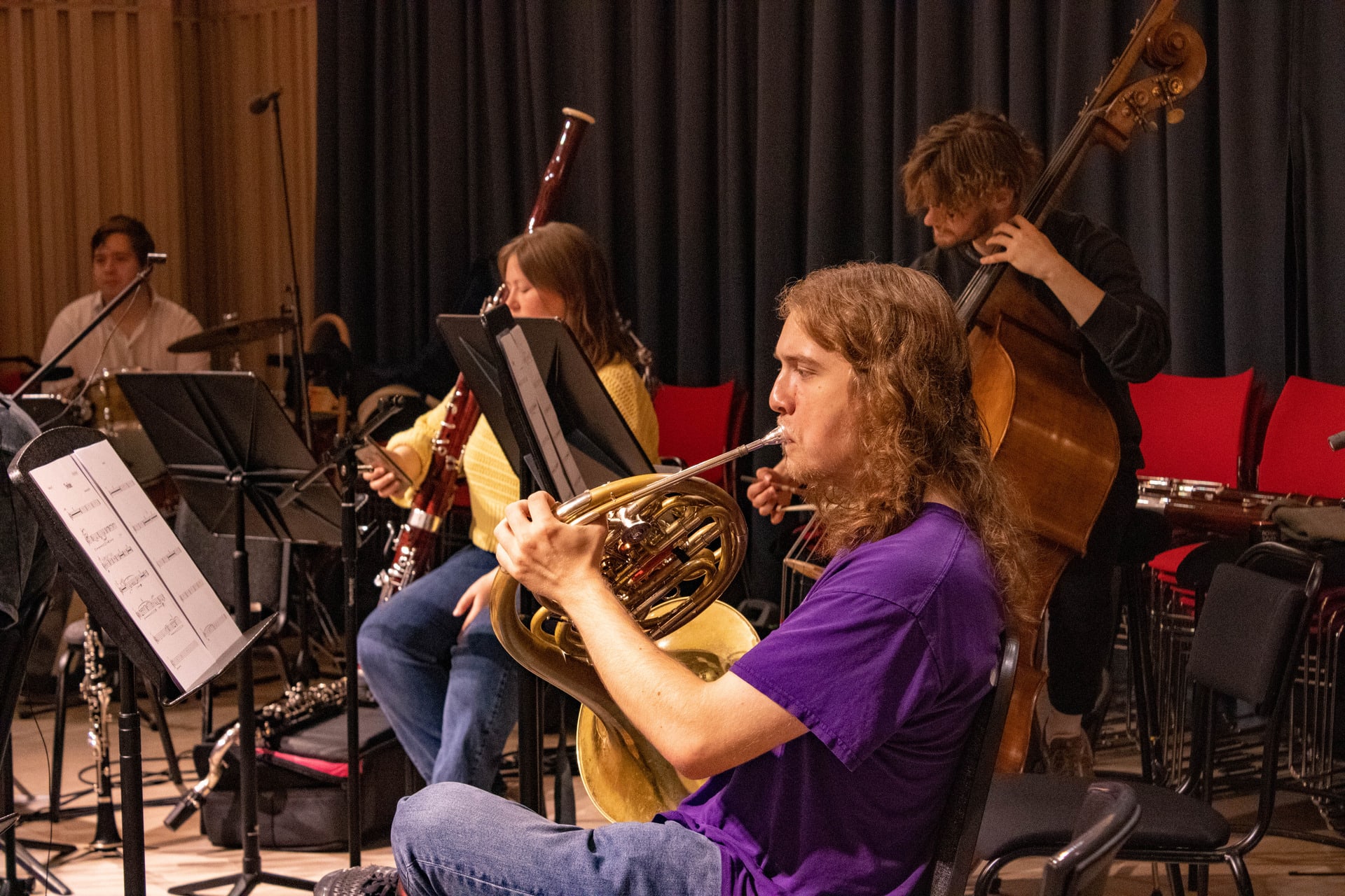 French horn player at music rehearsal