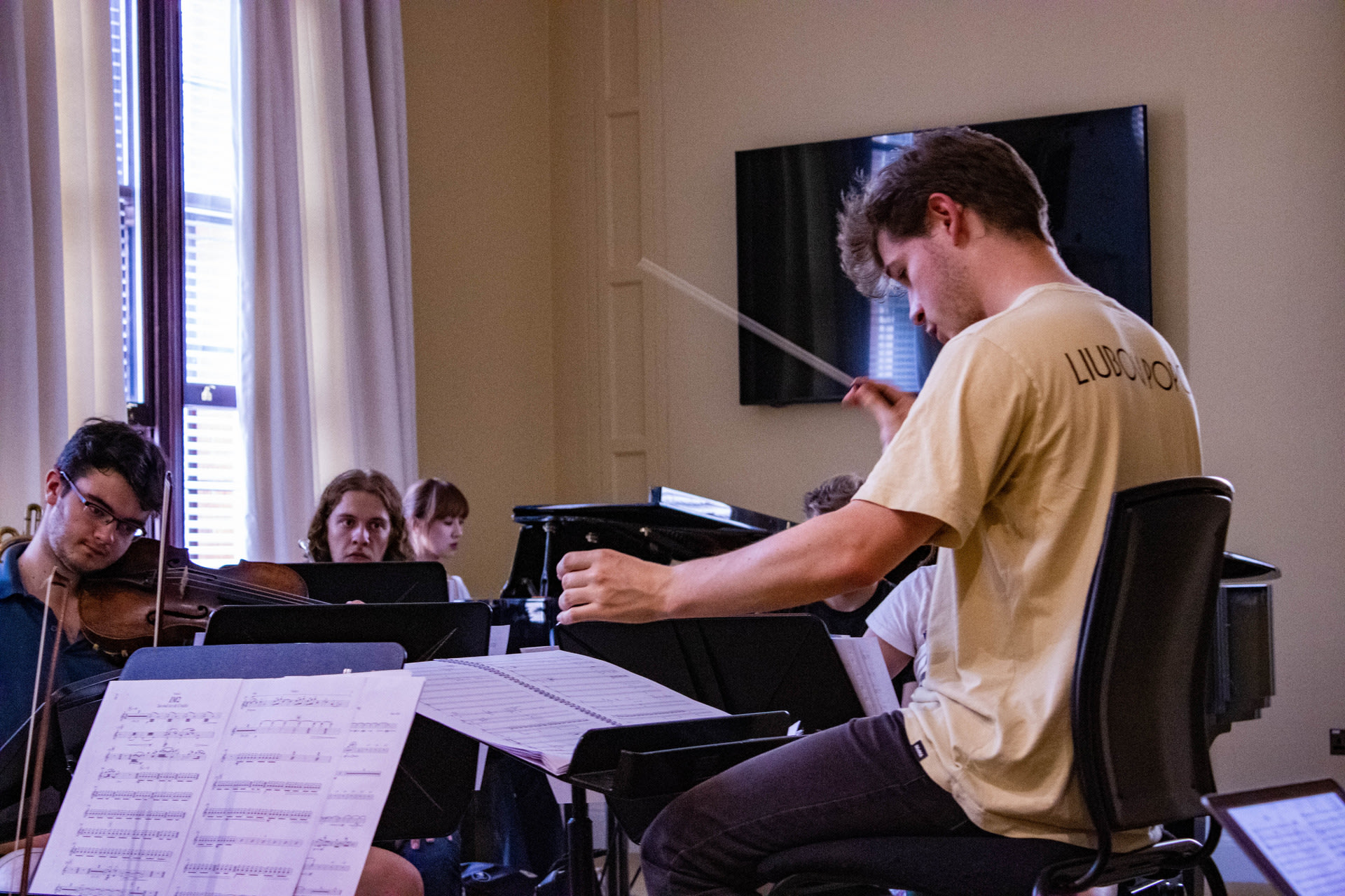 Conductor at music rehearsal 