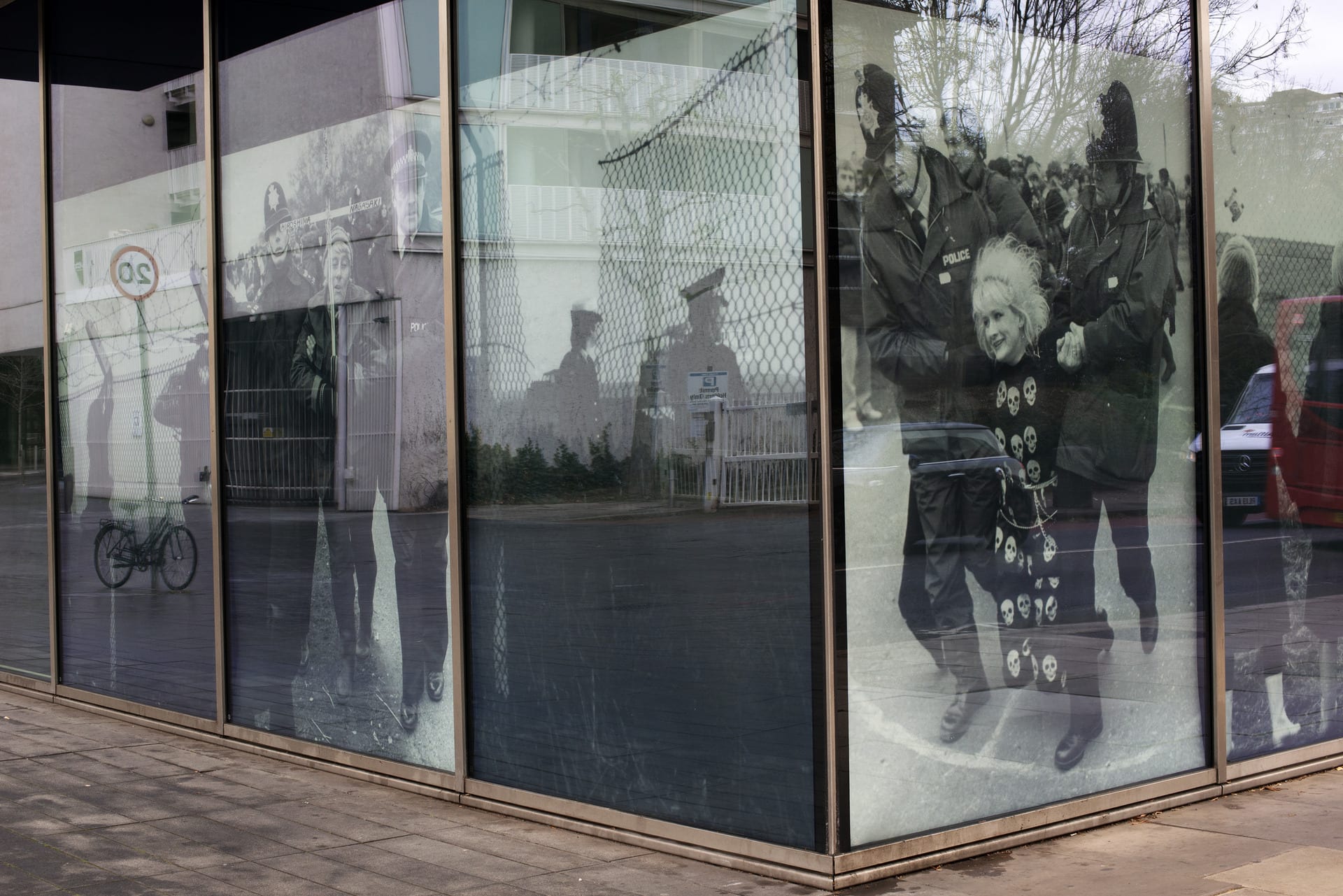 corner of window display showing woman protestor being dragged away by policemen