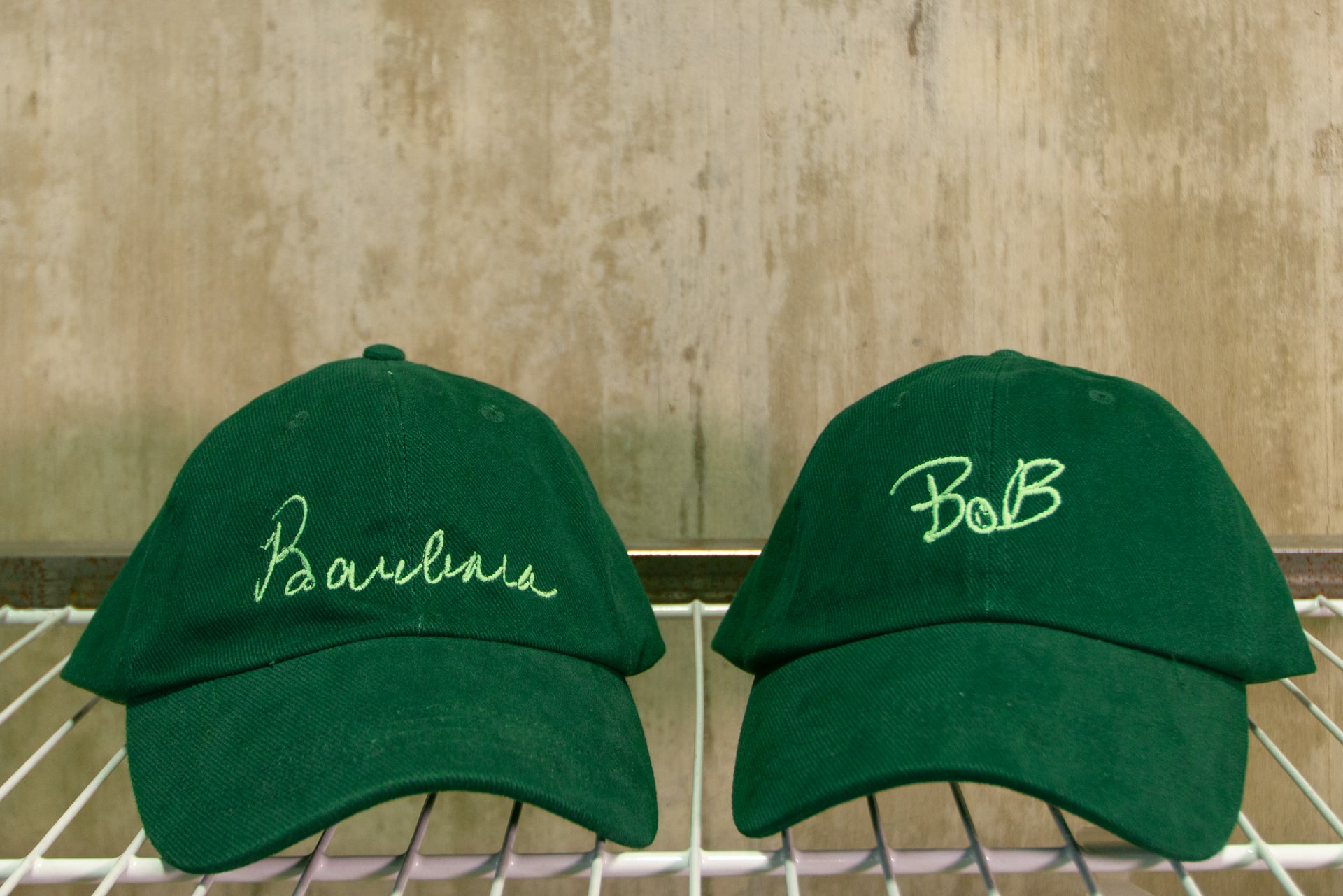 two baseball caps with signatures embroidered 