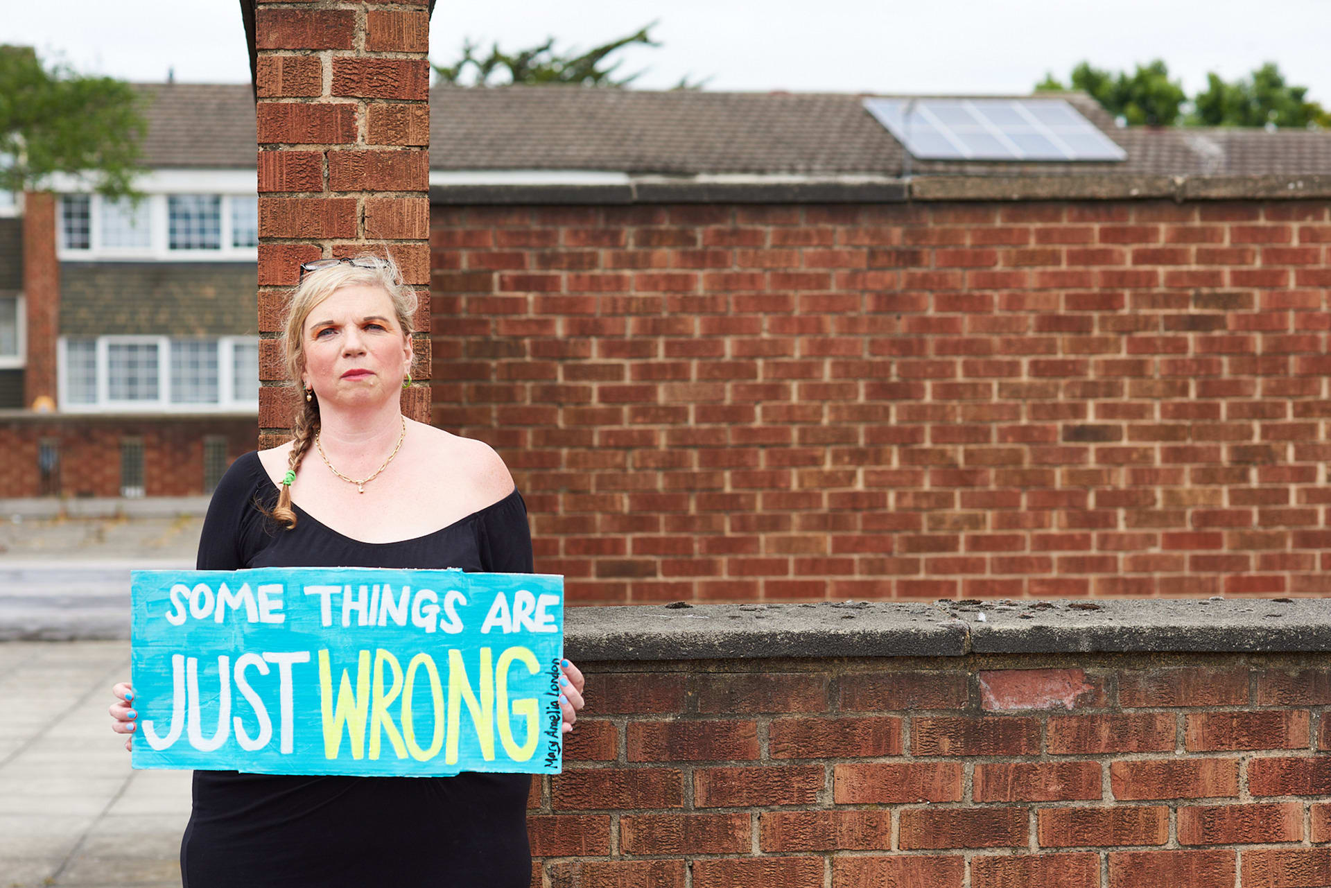 Mary Amelia London stands holding a sign saying: 'Some things are just wrong'