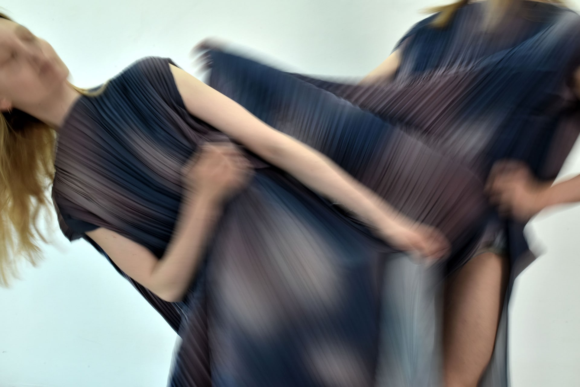 dancers blurred with blue and pink costumes moving into each other 