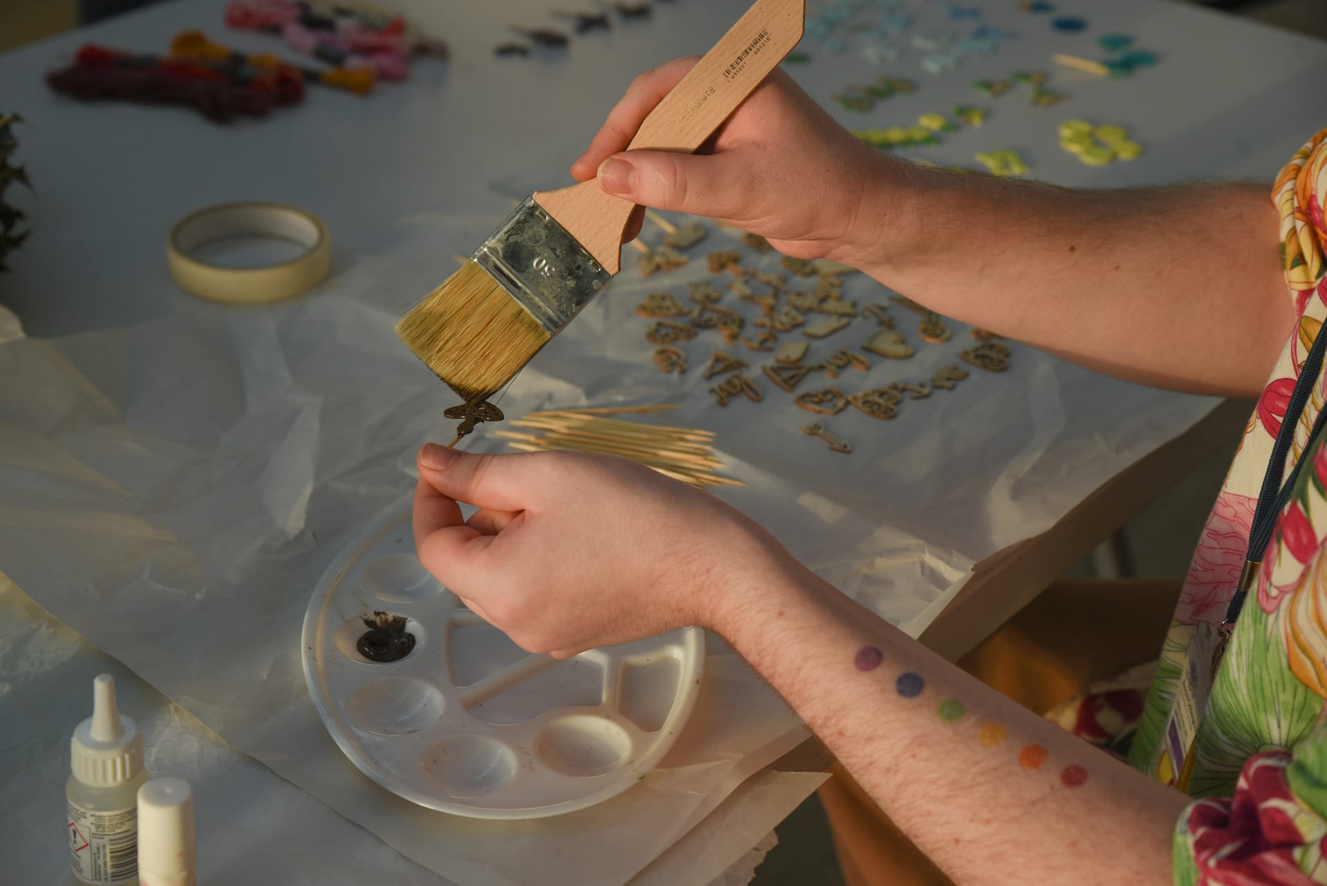 Painting a wooden mushroom symbol.