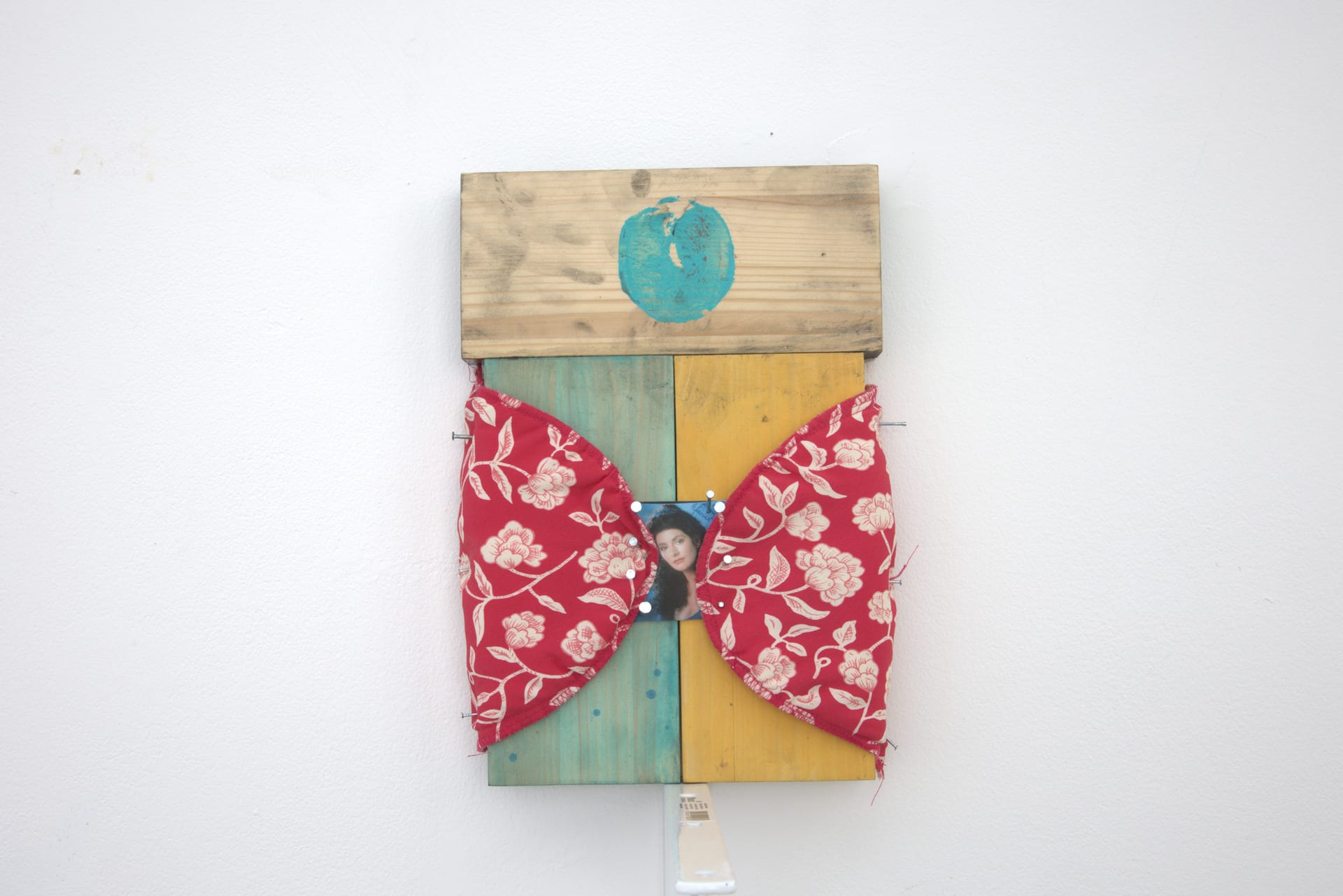 wooden blocks stuck together with printed paint marks. Fabric attached to make a curtain and a photographic image