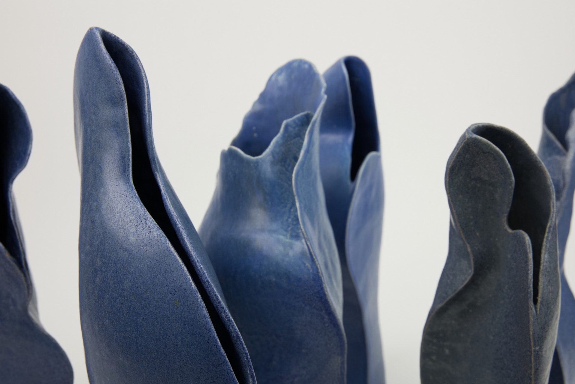 part of 6 blue curved ceramic vessels