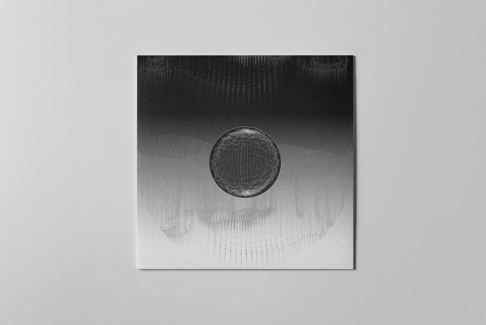 A vinyl record back in gray packaging with an intricate pattern.