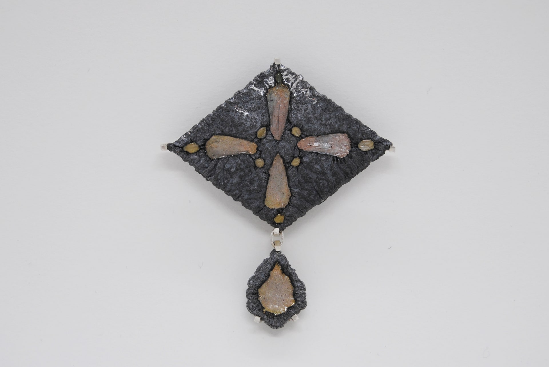dark oxidised silver and enamel brooch in diamond shape with drop detail beneath