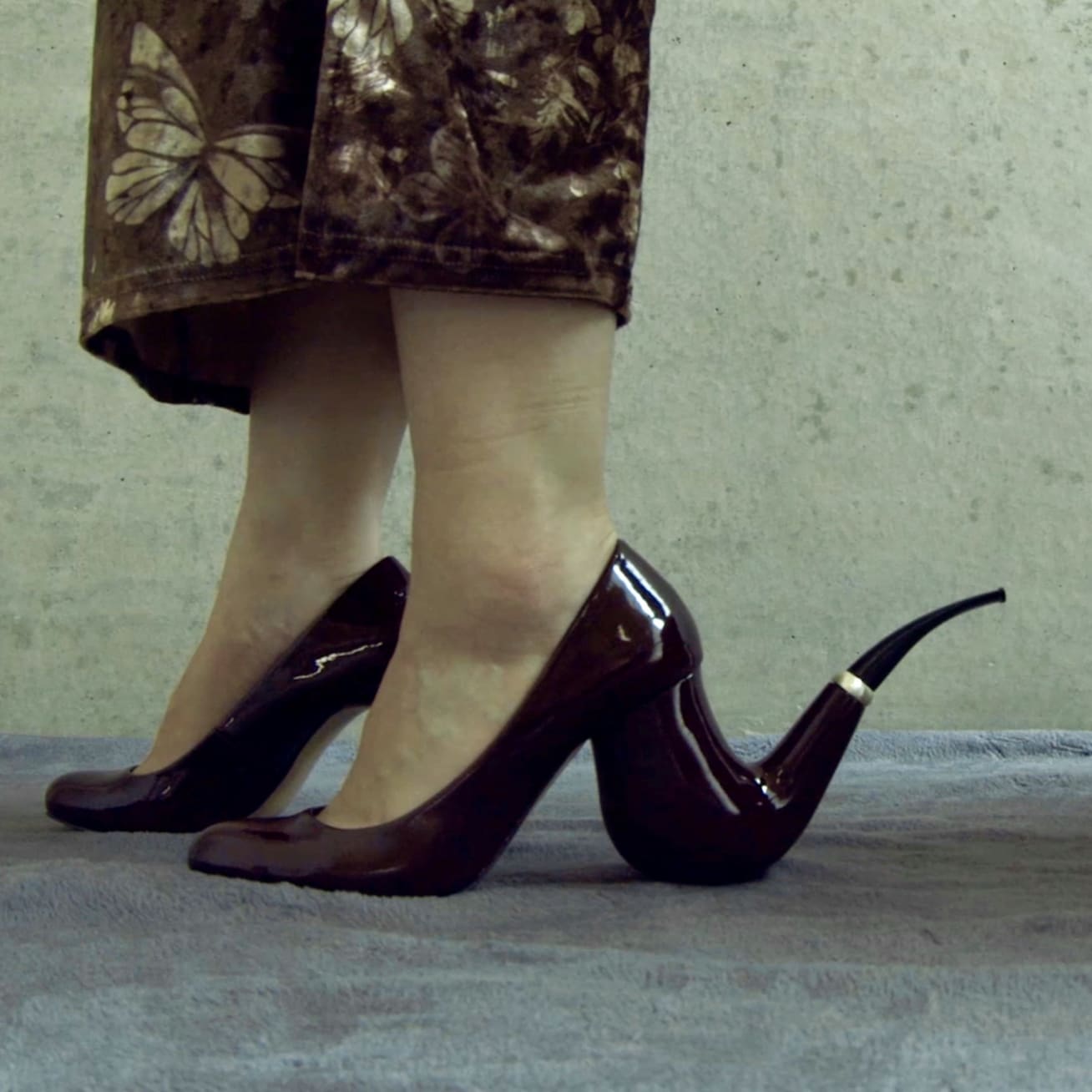 a woman wearing a high heel and pipe assemblage 