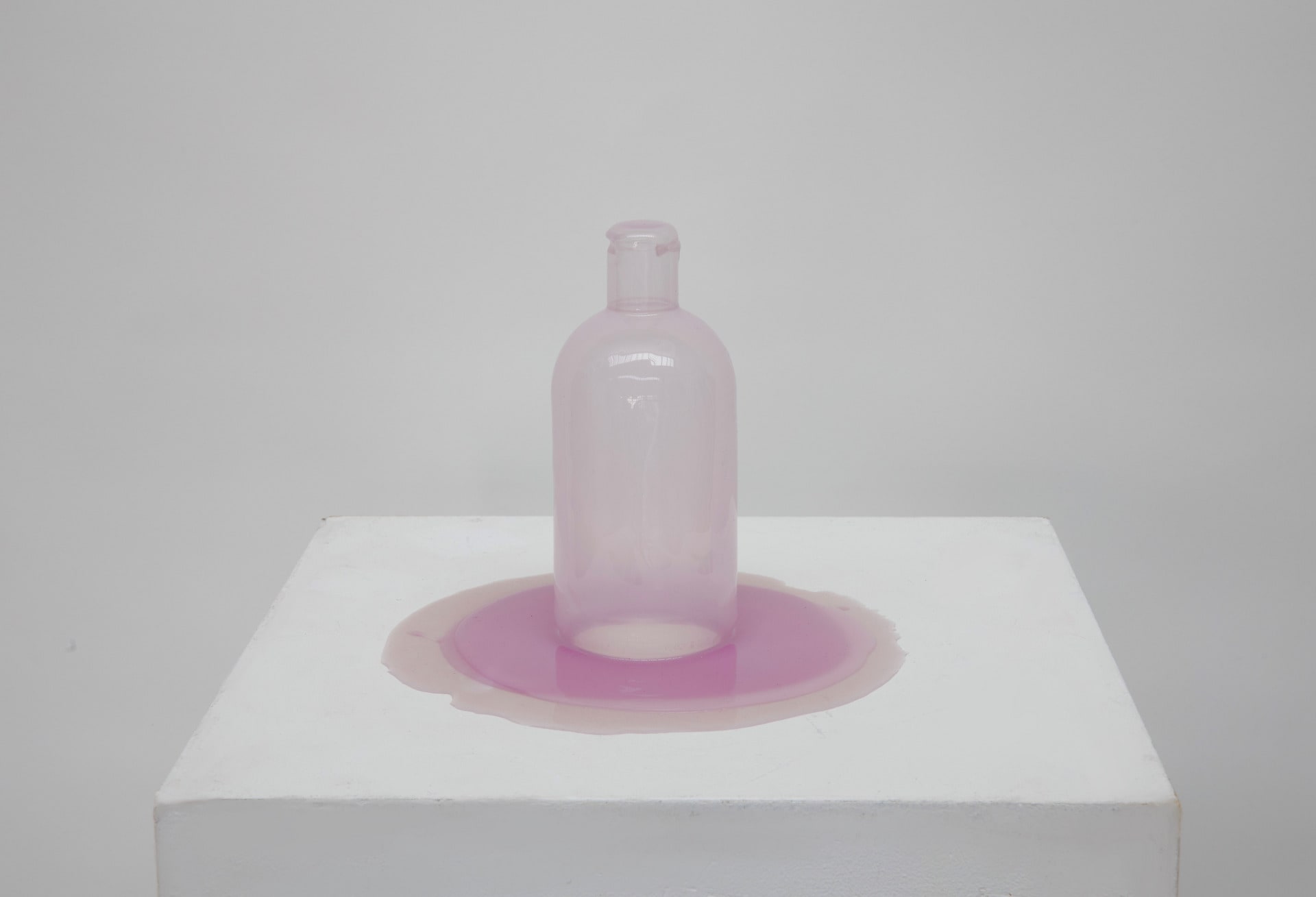 Purple bottle cast on a plinth. 