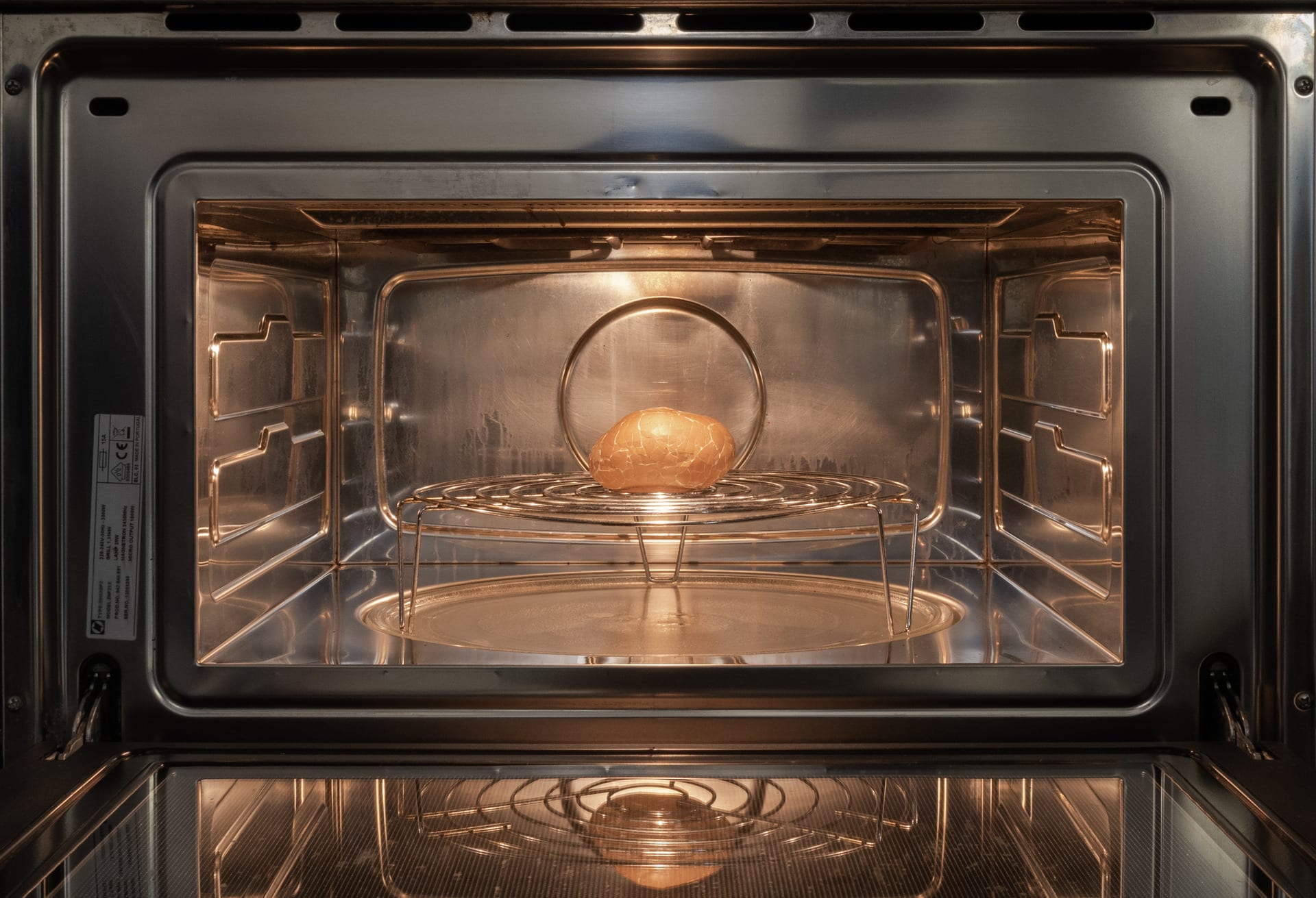 A misshapen egg is placed in the microwave.