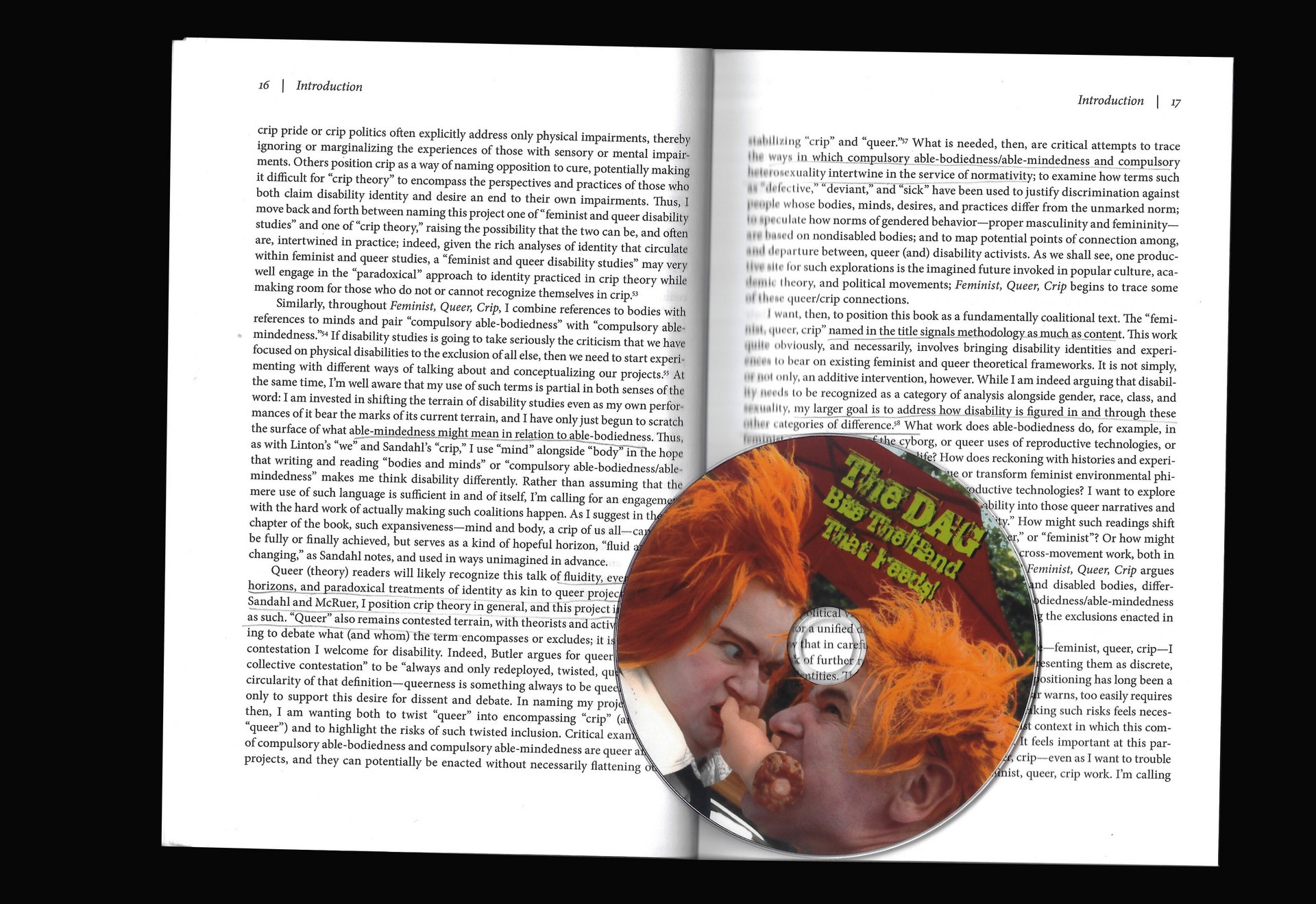 A scan of a spread from Alison Kafer’s Feminist Queer Crip and a DVD by Disabled Avante Garde called Bite the Hand that Feeds