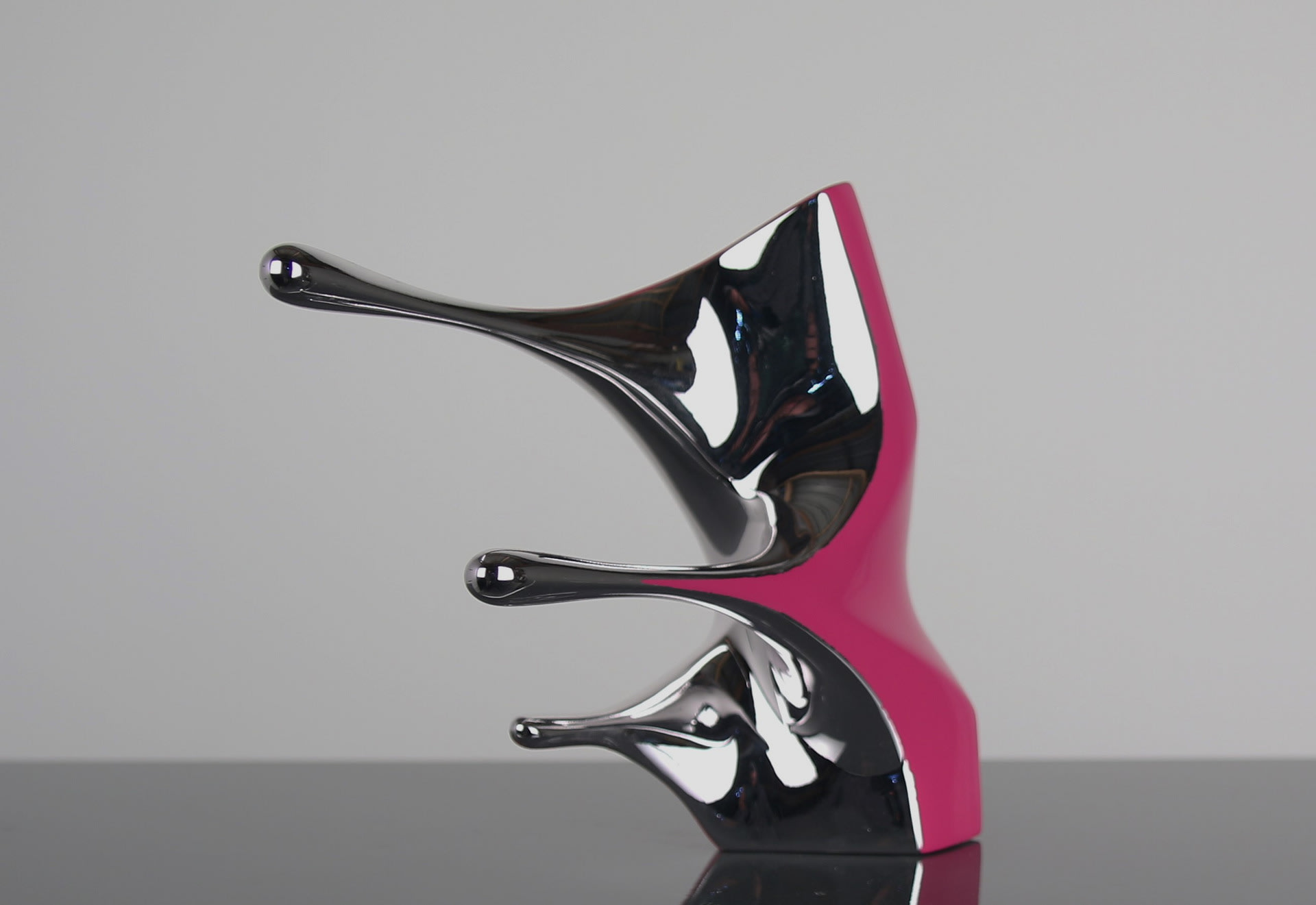 Pulling and stretching from the centre of the sculpture, Pink and chrome surface