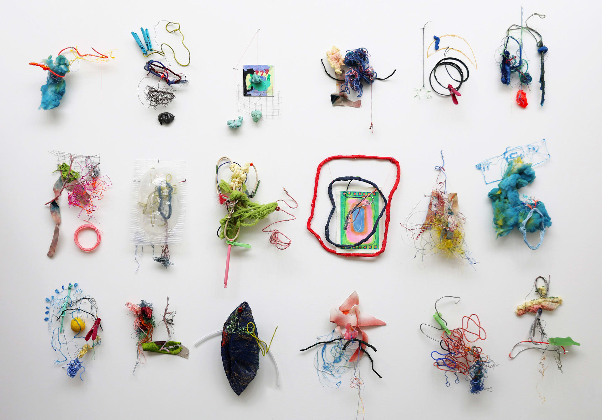 Colourful mixed media wall sculptures made of waste and found materials 