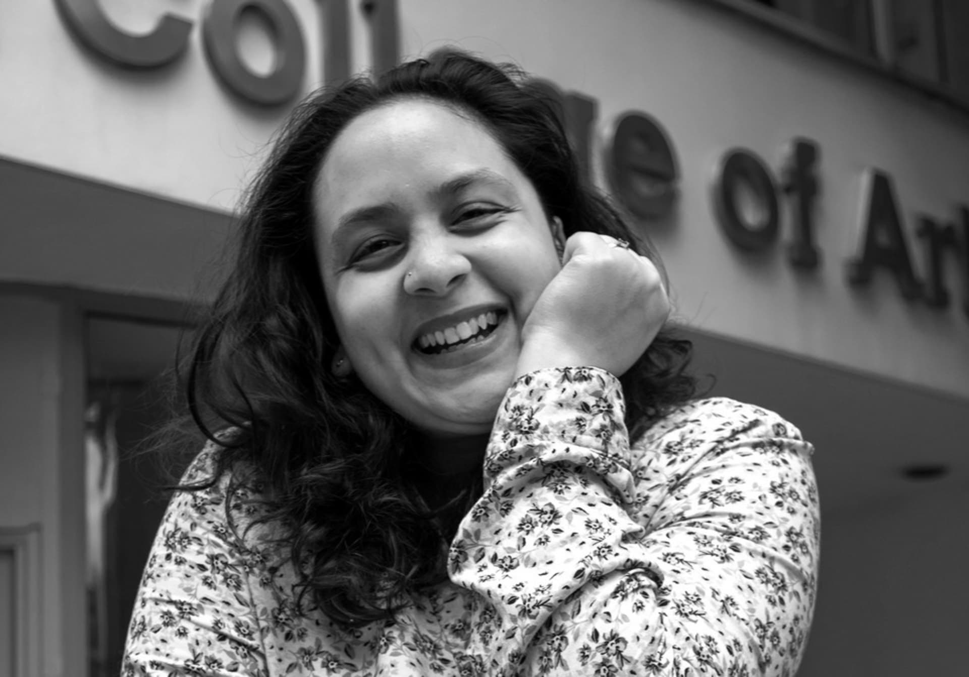 Black and white photograph of Irushi Tennekoon outside the RCA in Kensington