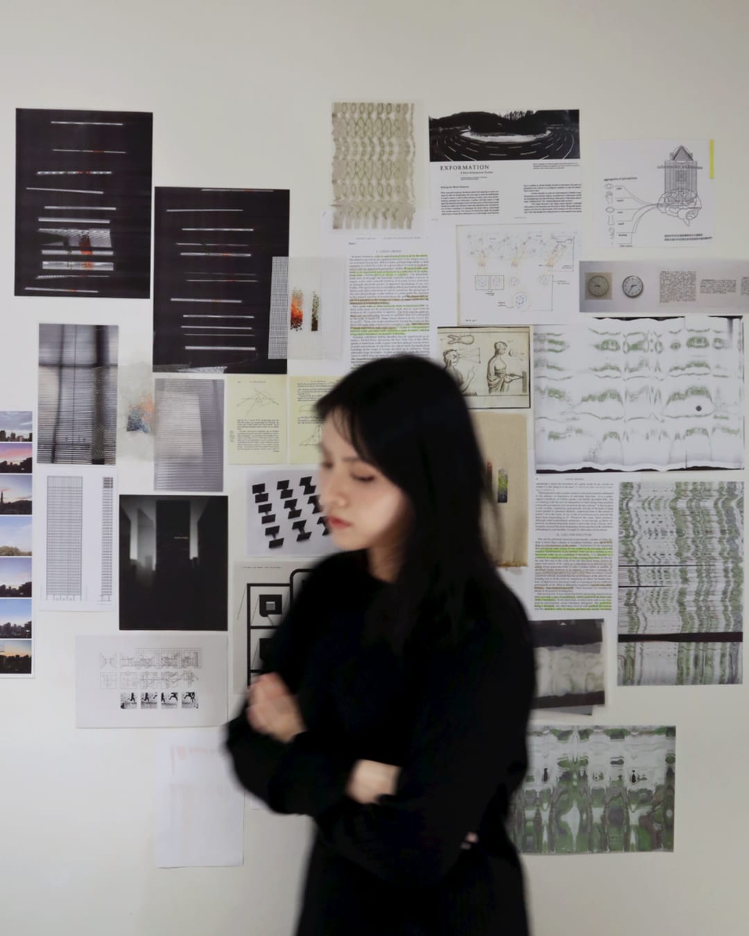 artist in front of the inspiration wall