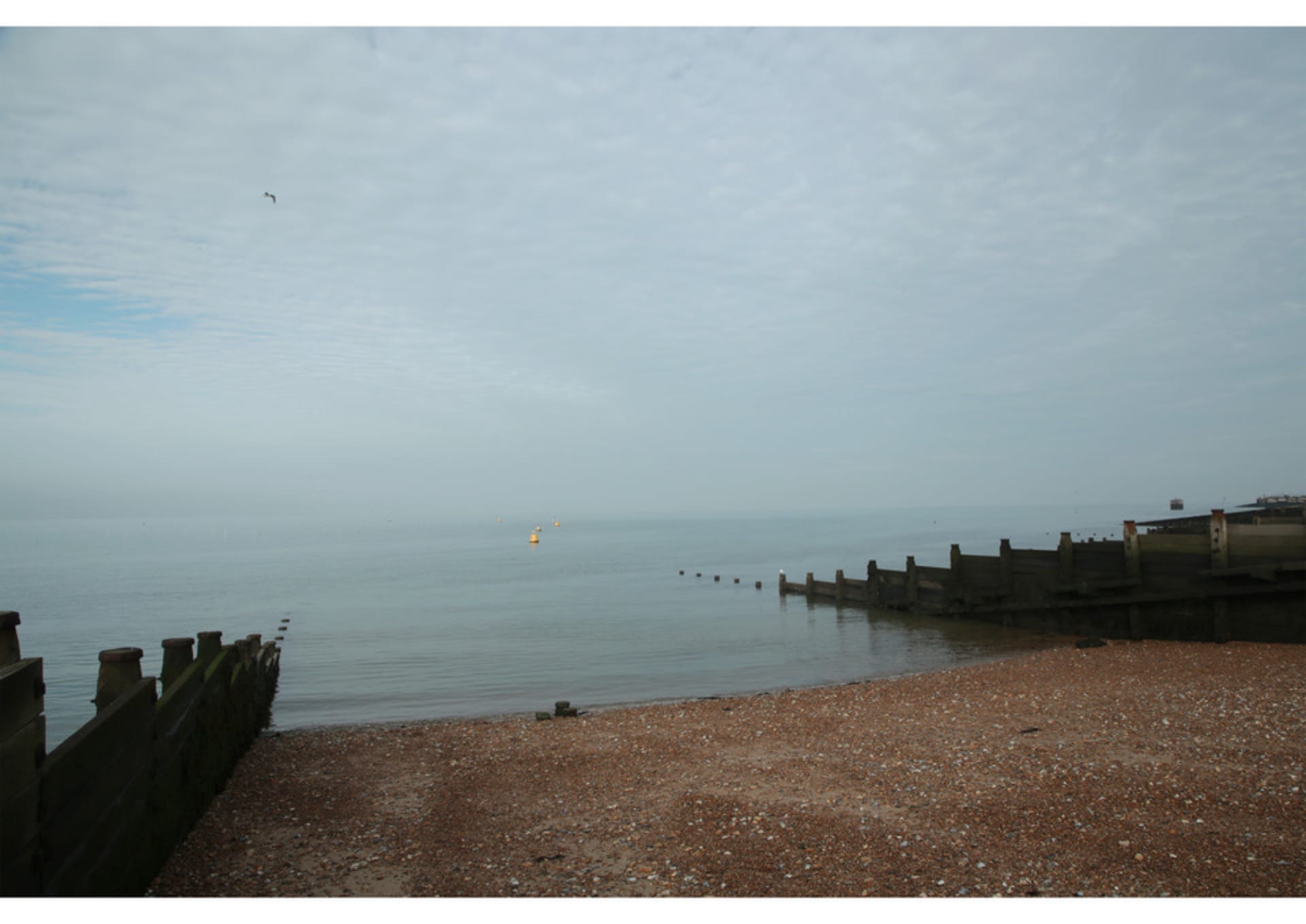 Photo of Lucy and Grandfather on the beach at Whitstable, 1998